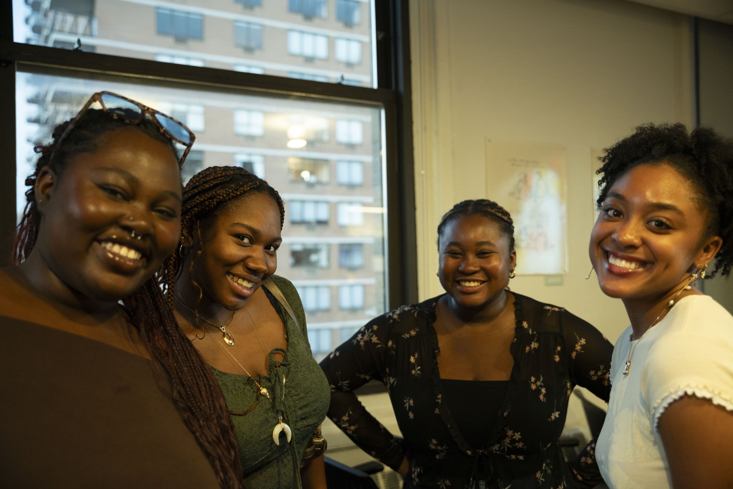 Photo of four e-board members at the fall 2024 welcome mixer.