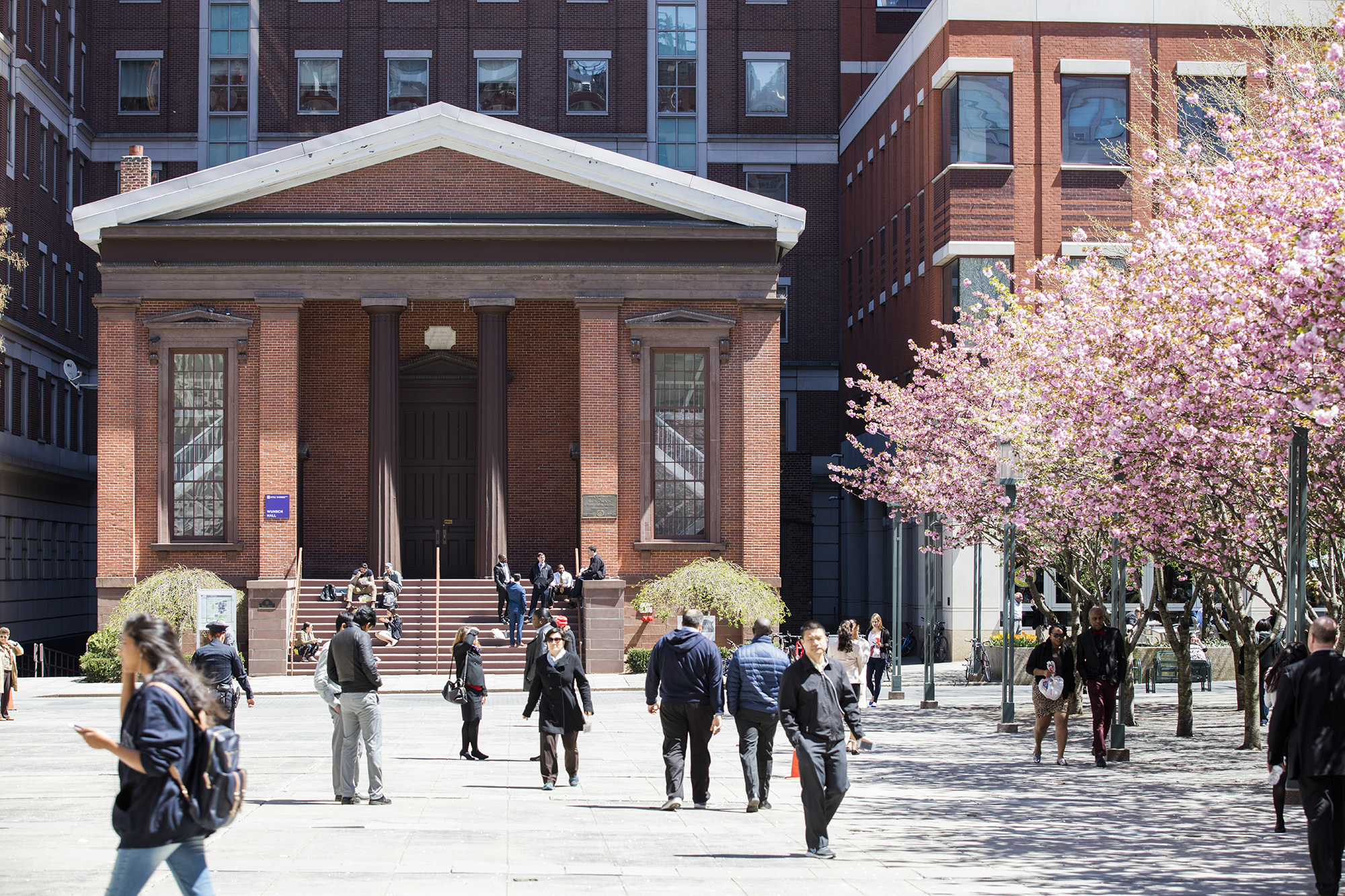 Exterior of The Wunsh Building with students walking by.