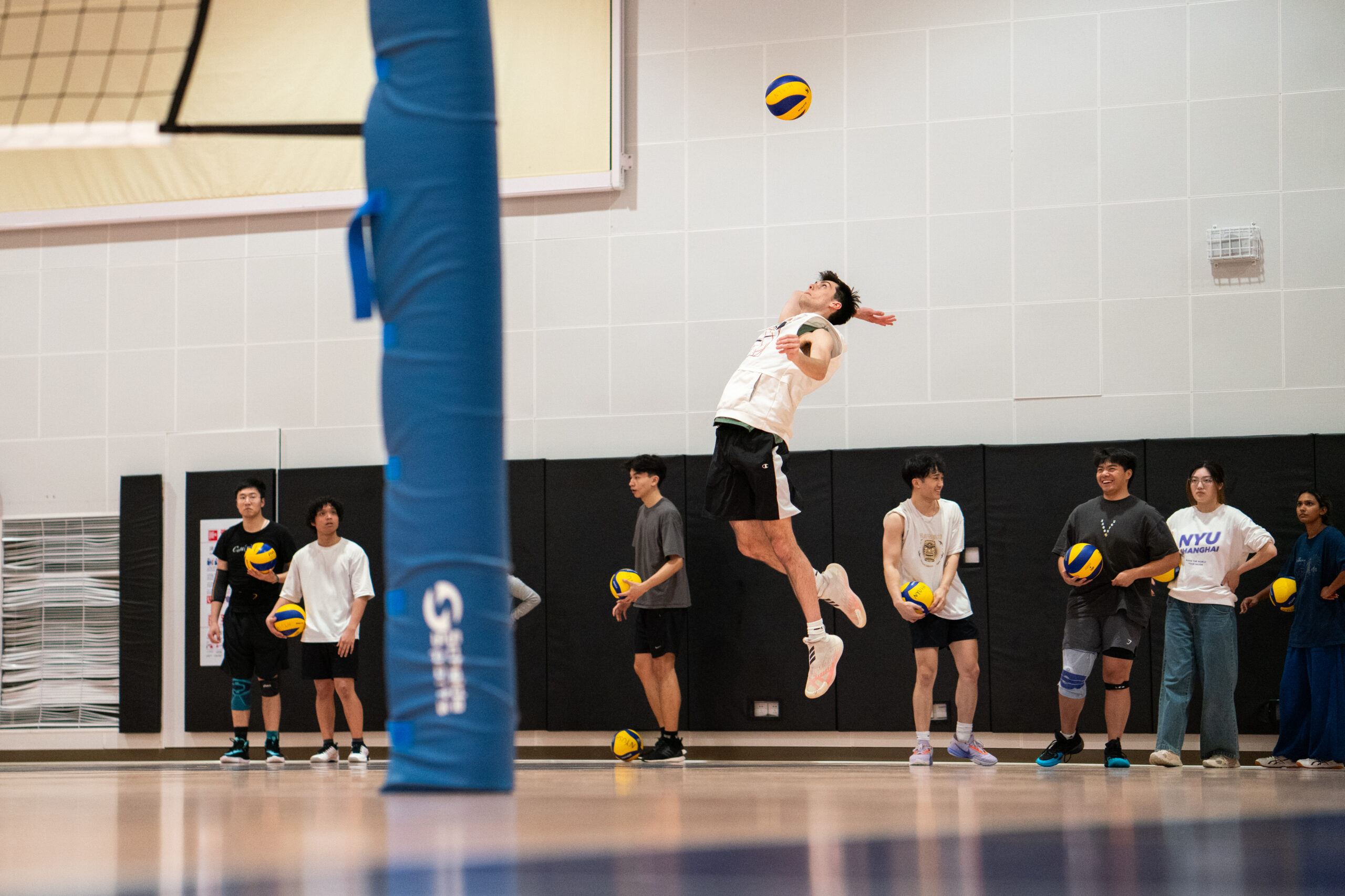 A group of students playing volleyball.