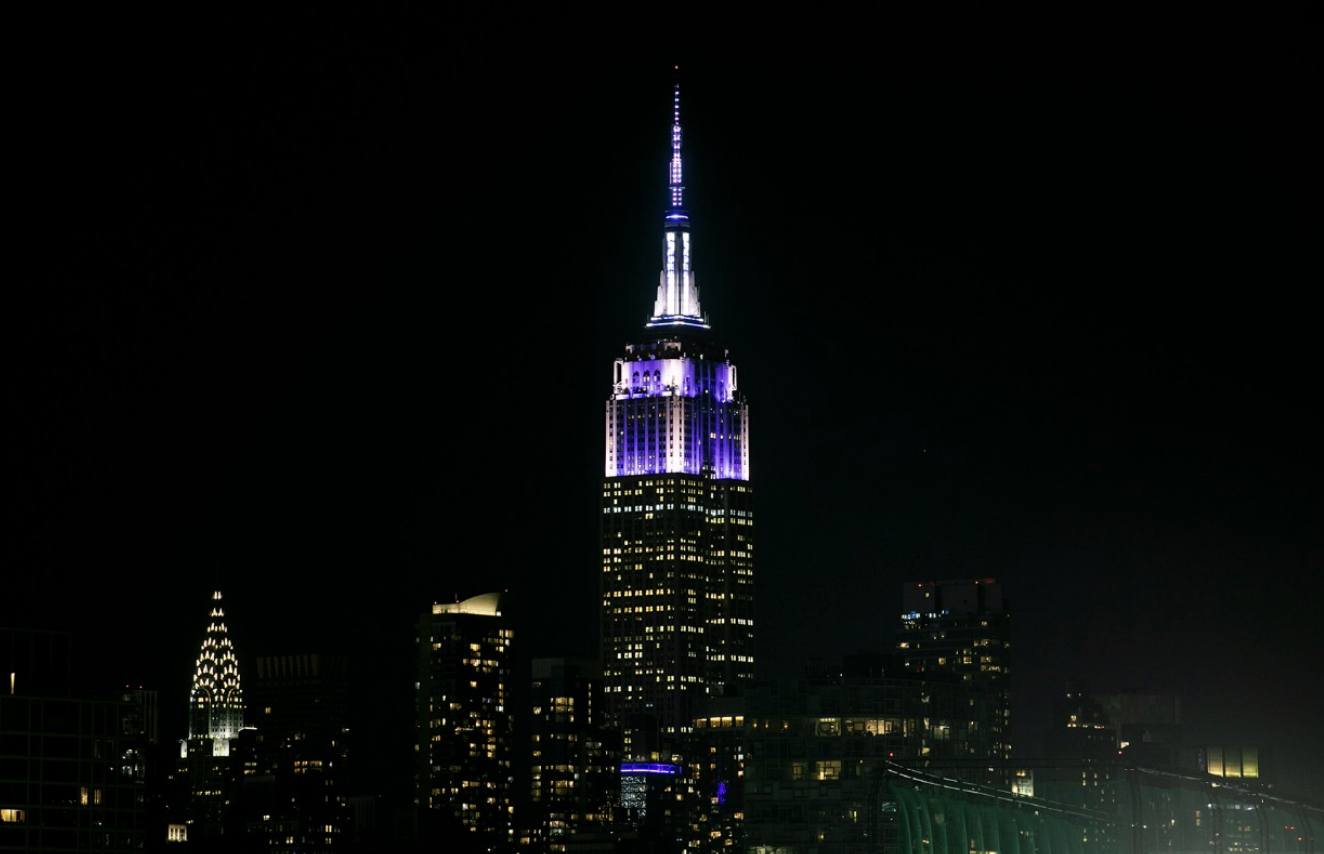 Empire State Building lit up in NYU violet and white