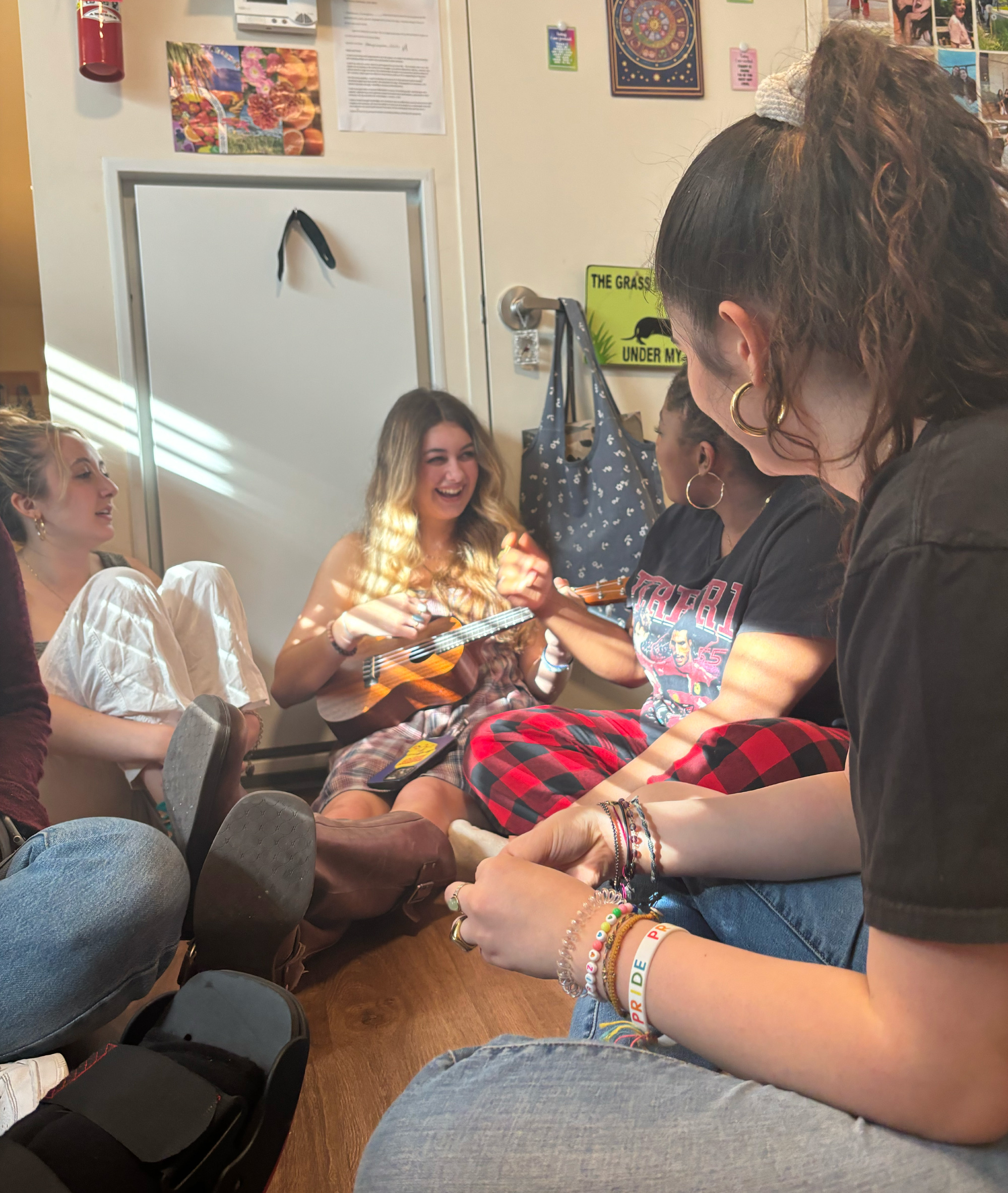 A group of students hanging out in a dorm room.