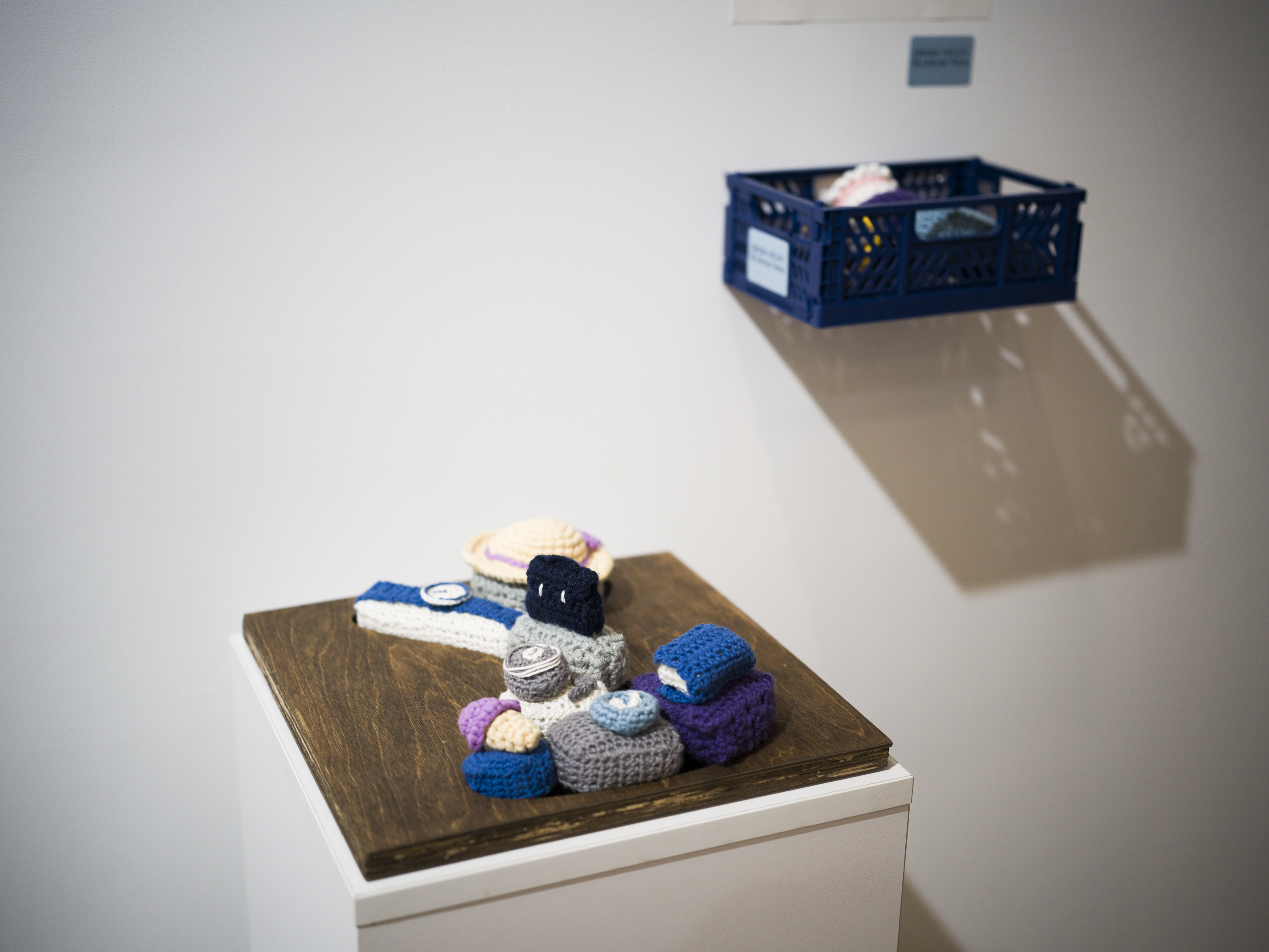 Documentation photo of puzzling time, a piece with a timer-shaped wood base and various crochet puzzle pieces