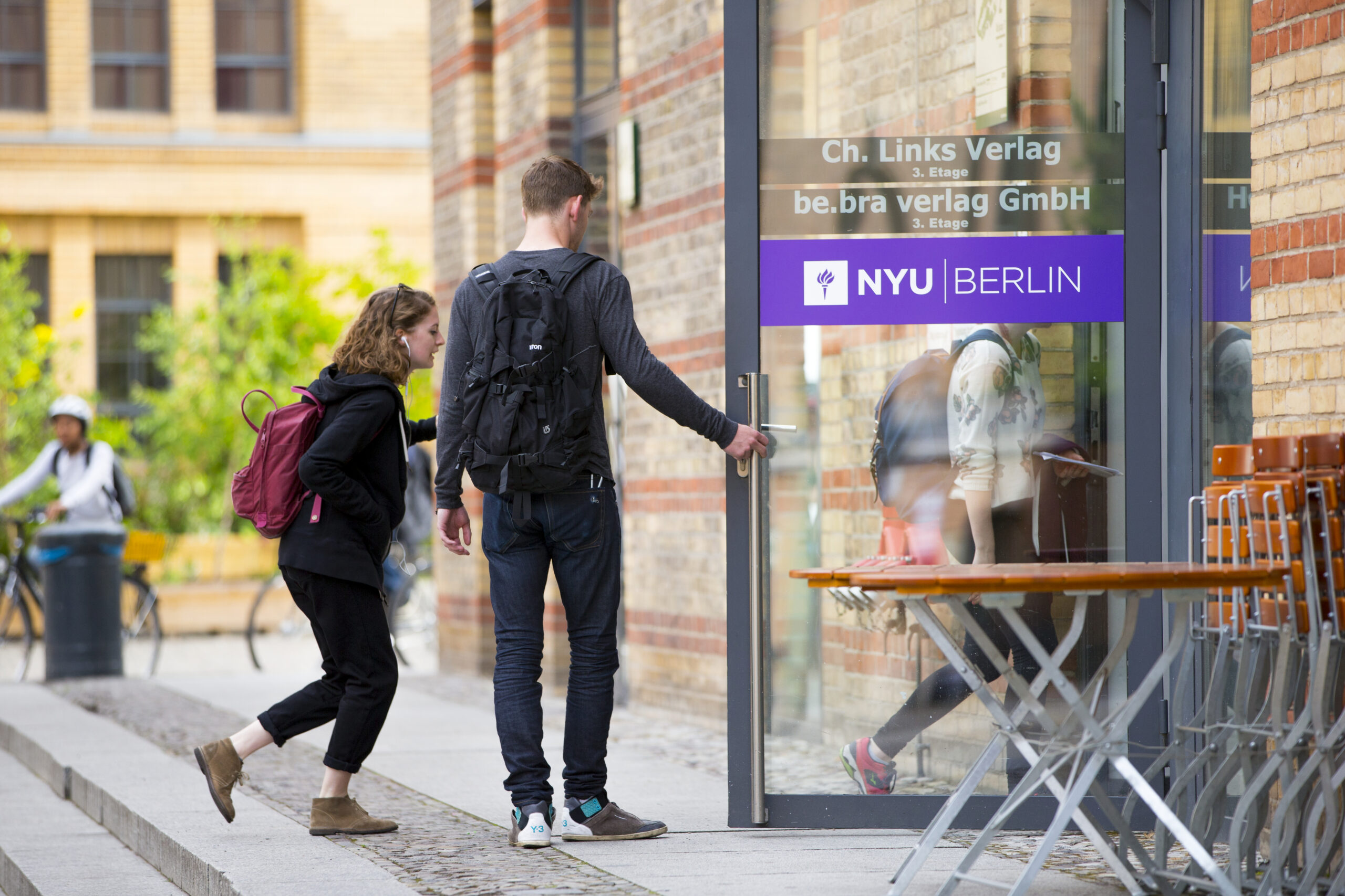 Two students entering an NYU Berlin building.