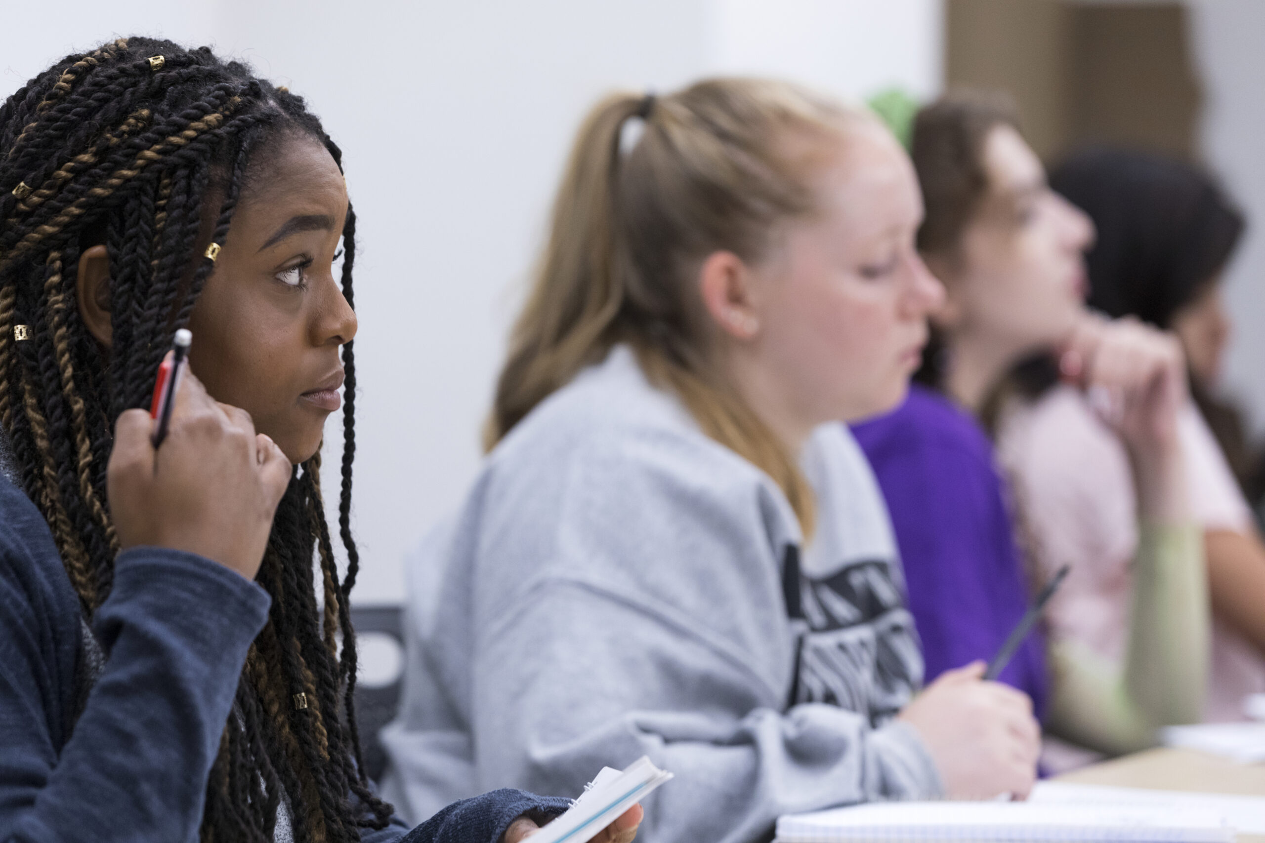 Students listening and taking notes.