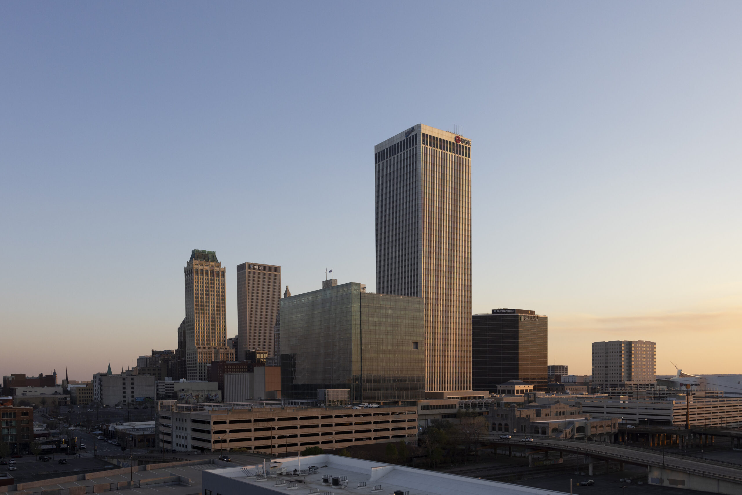 The sun setting behind NYU Tulsa’s skyline.