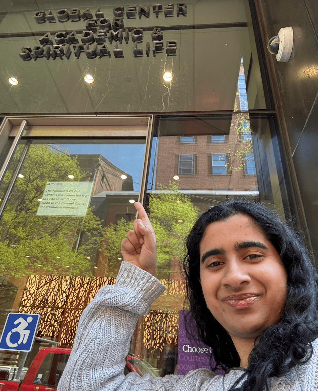 a girl pointing at a building