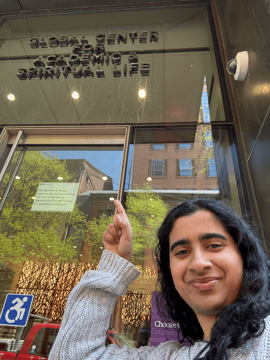 a girl pointing at a building