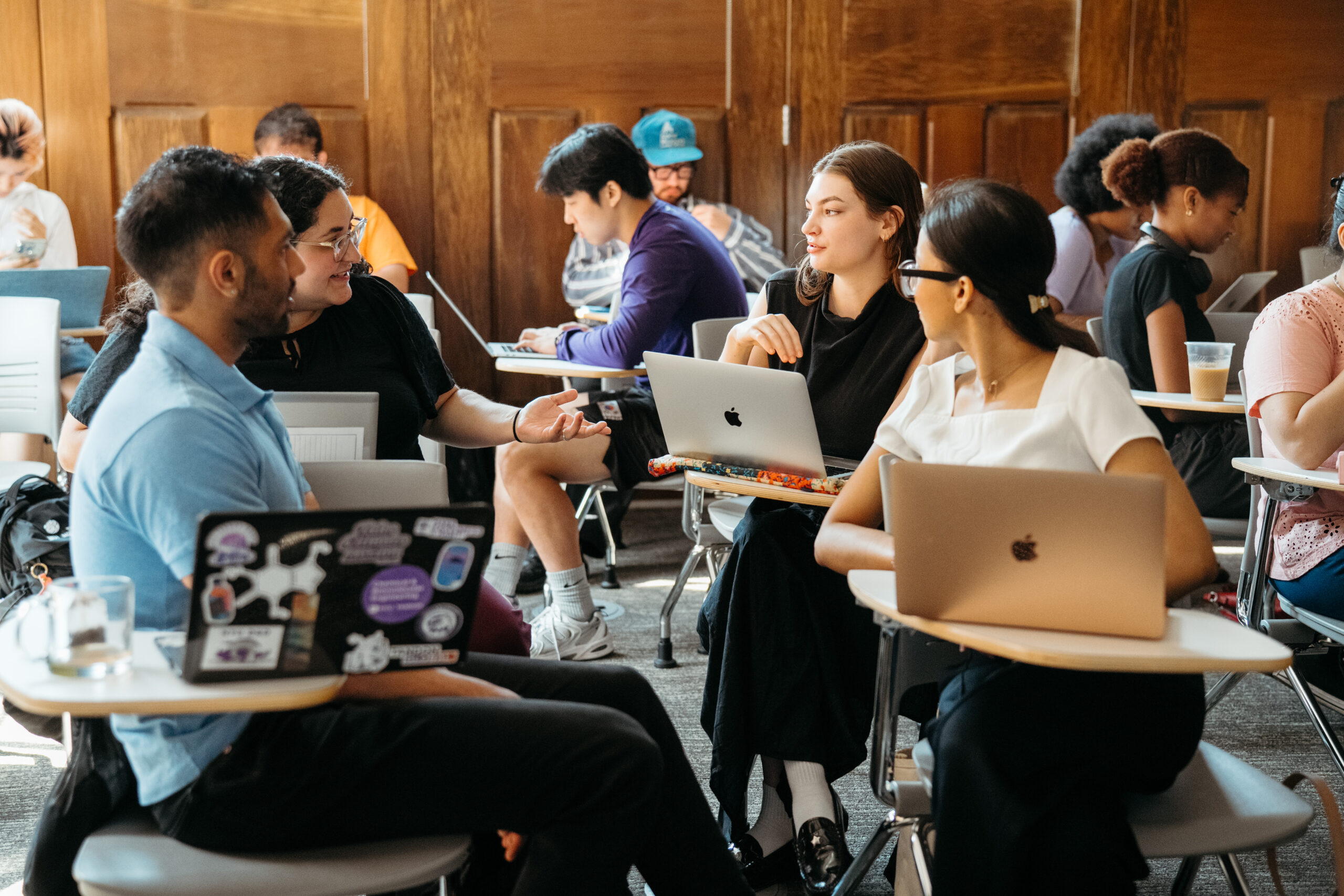 A group of students talking together in class.