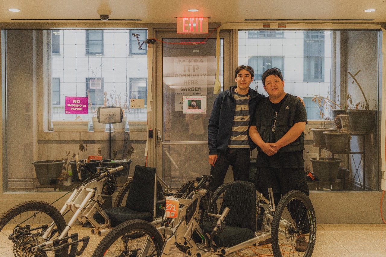 Jackson Kollmorgen and Yuxiang Cheng standing behind the custom mountain bikes they designed.