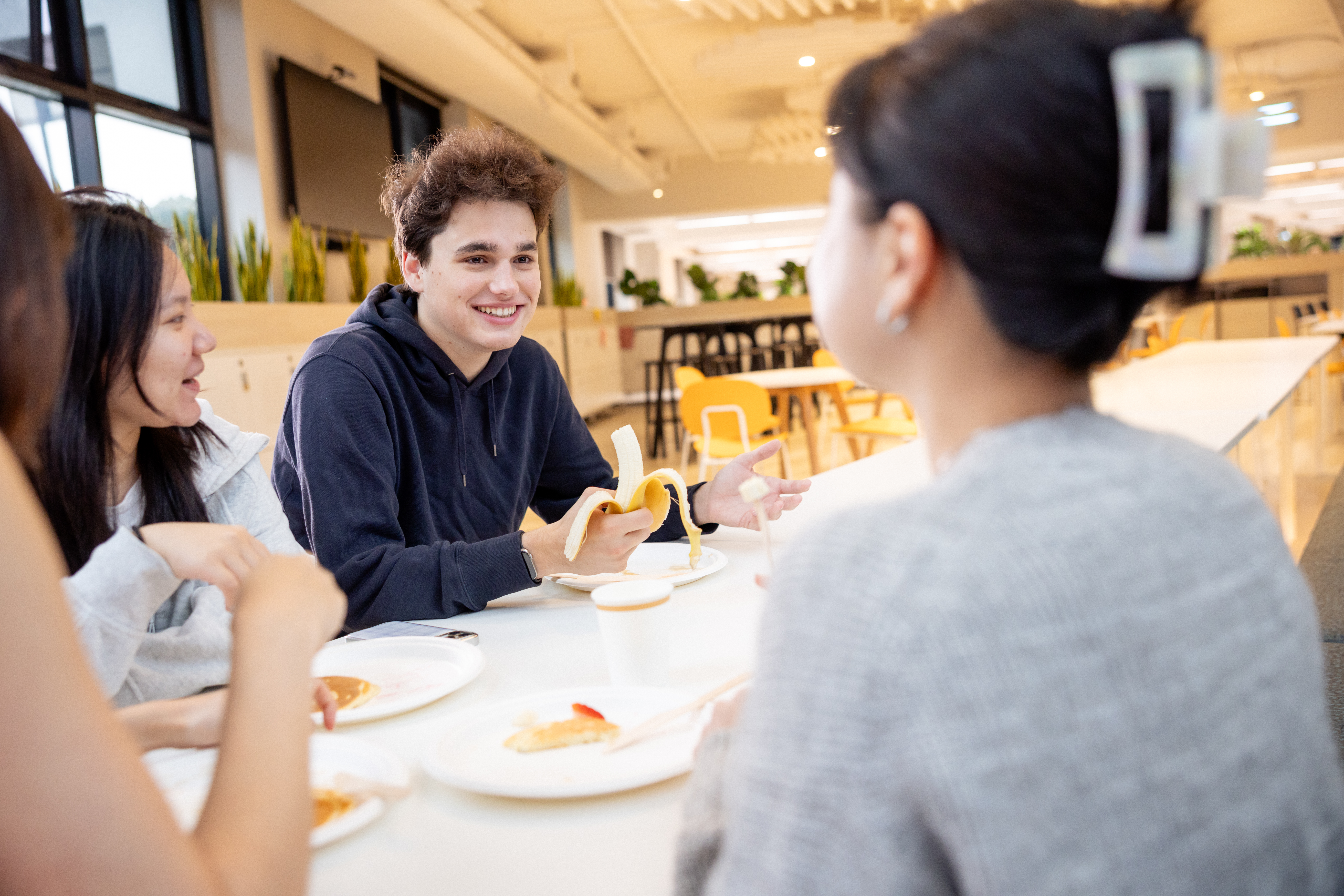 Students eating a meal together.