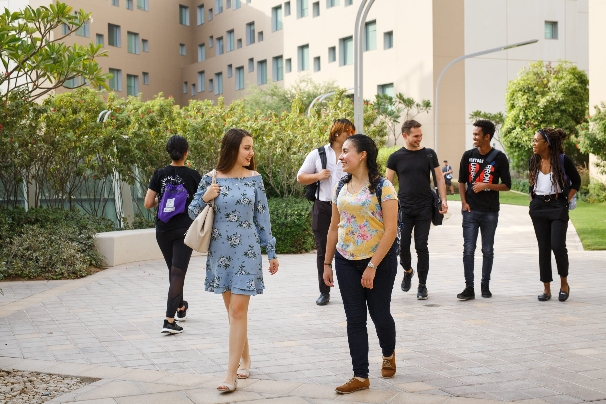 A group of students walk on the NYU Abu Dhabi campus.