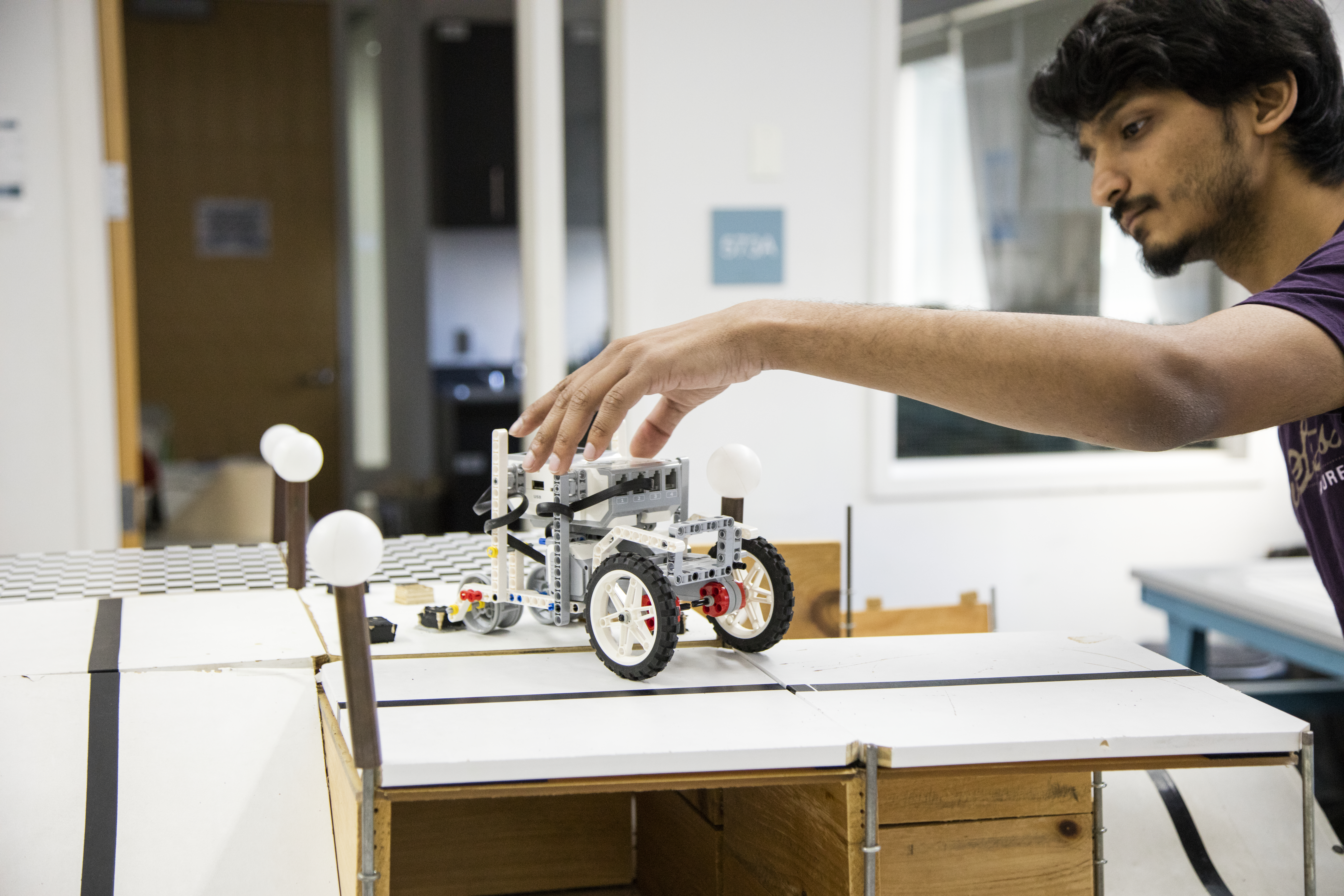 A student works with a robotic project.