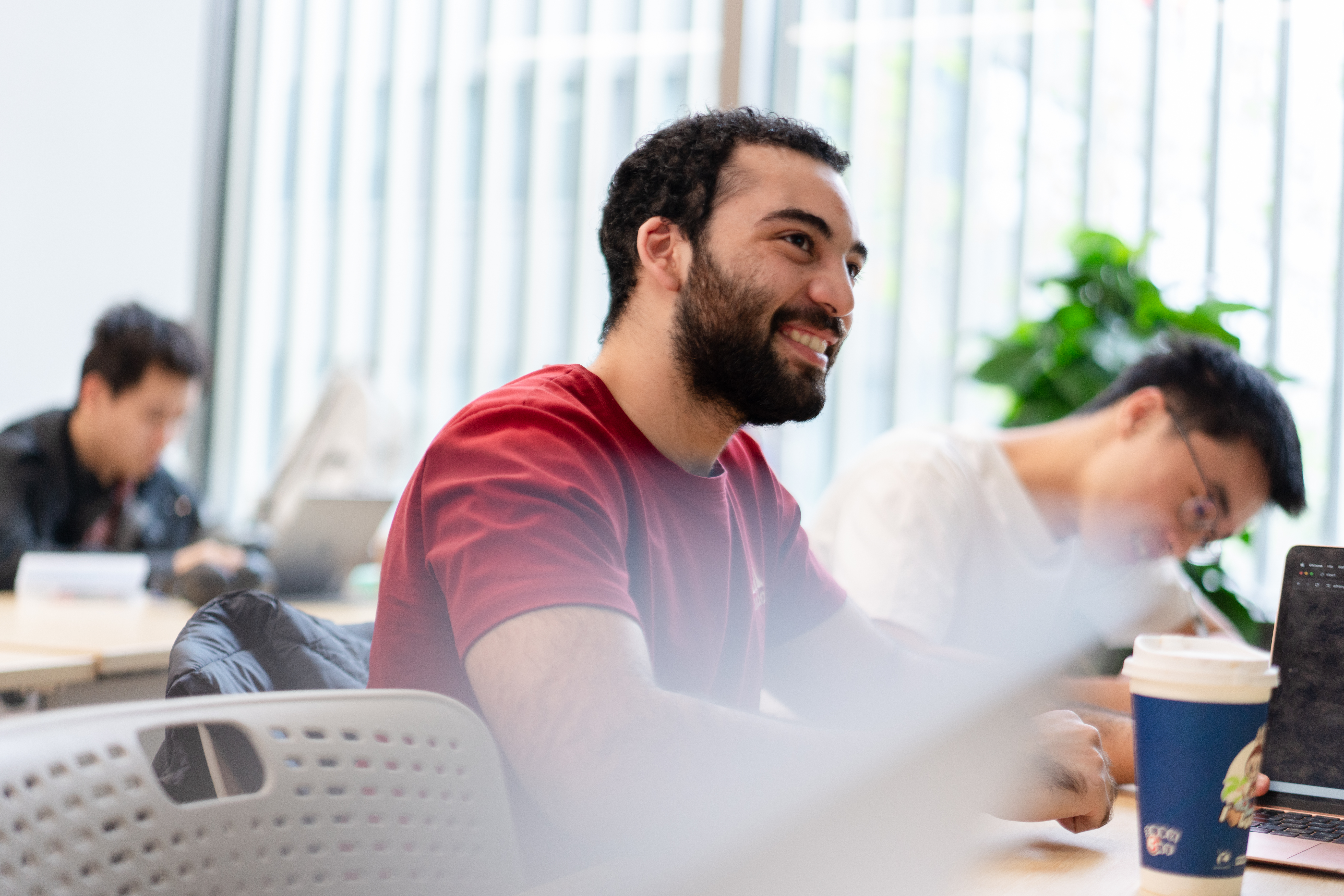 A smiling student in class.