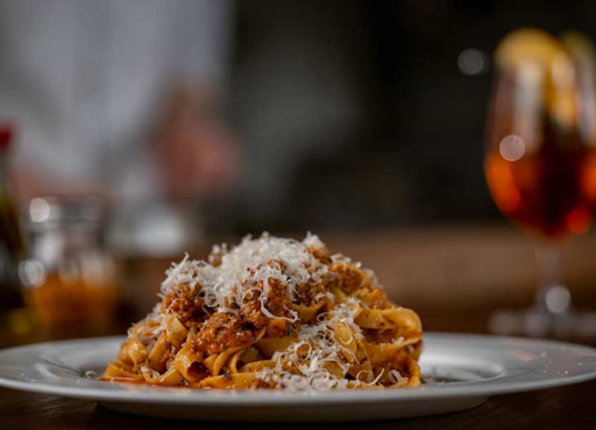 A plate of pasta on a dining table.