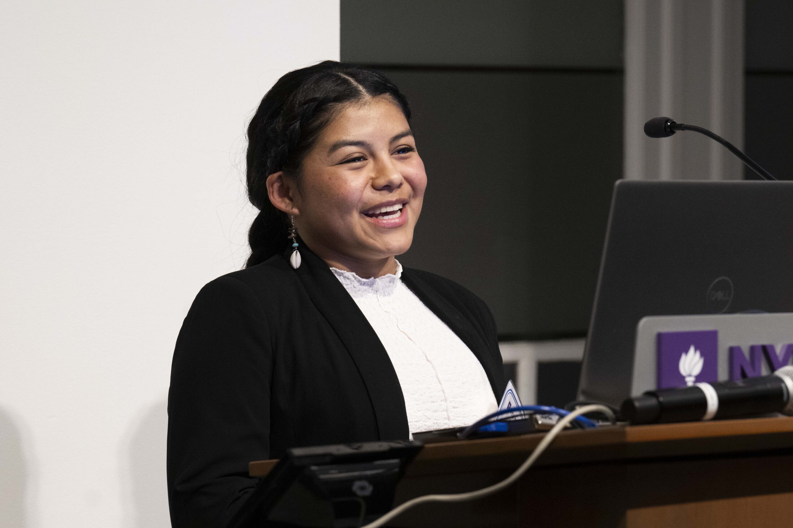 Student Wendy Benitez Jaramillo speaking at a conference.