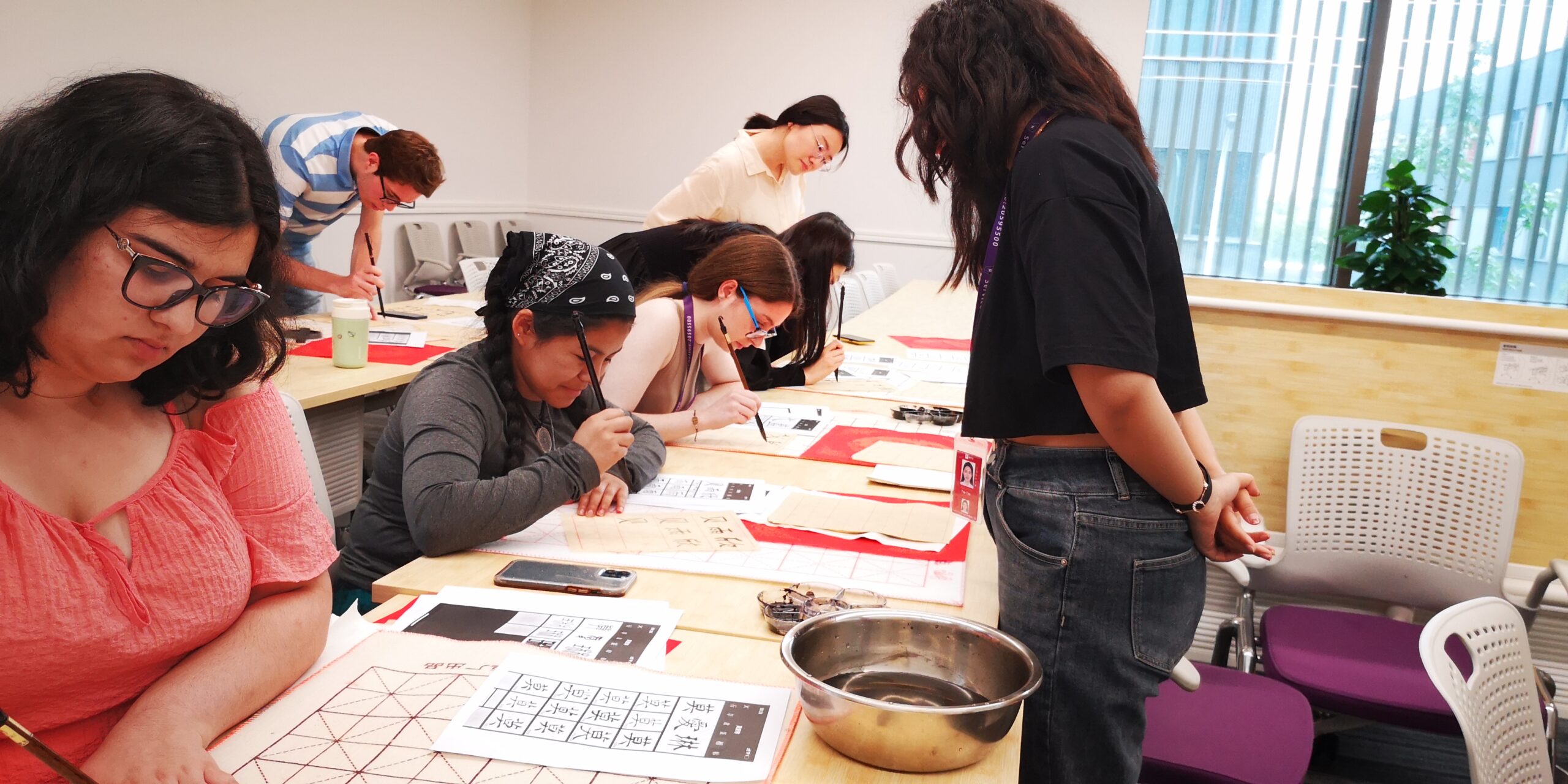 Wendy practicing Chinese calligraphy with other students in her Summer Chinese Language Immersion Program.