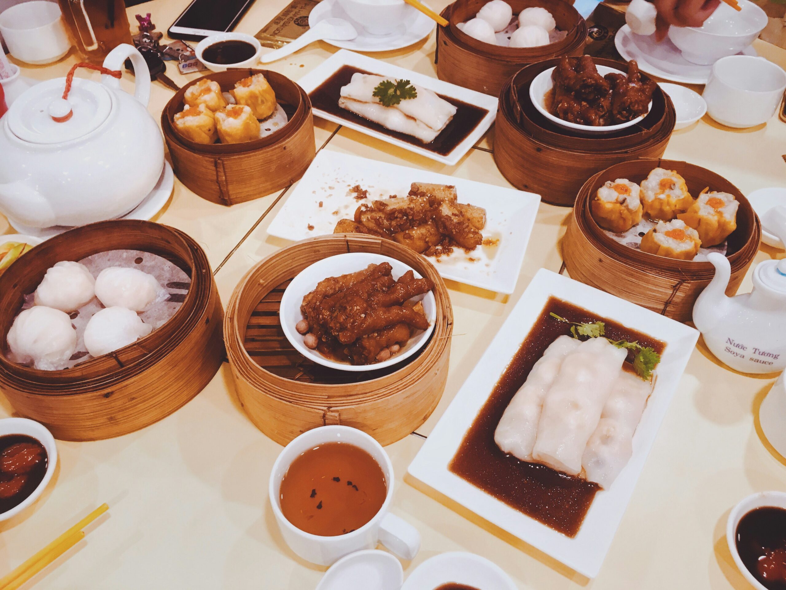 A table full of traditional dim sum food.
