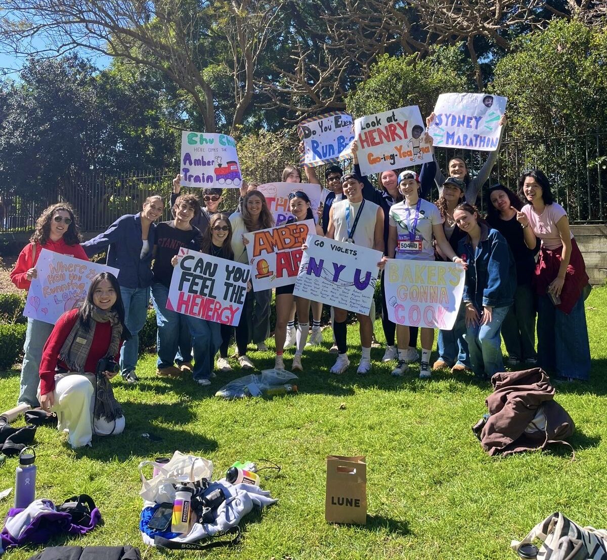 A large group of students holding up homemade signs as a show of support.