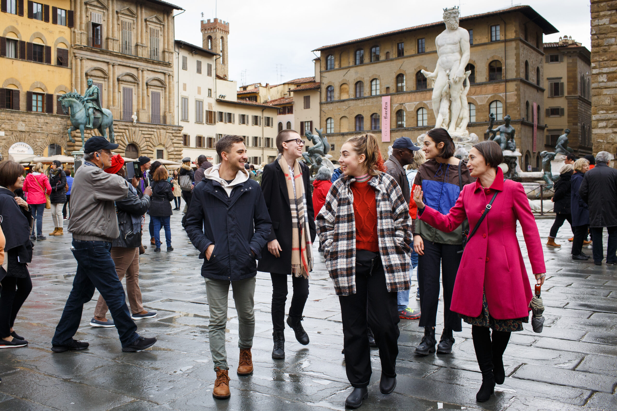 A group of students walking around Florence, Italy, with a professor.