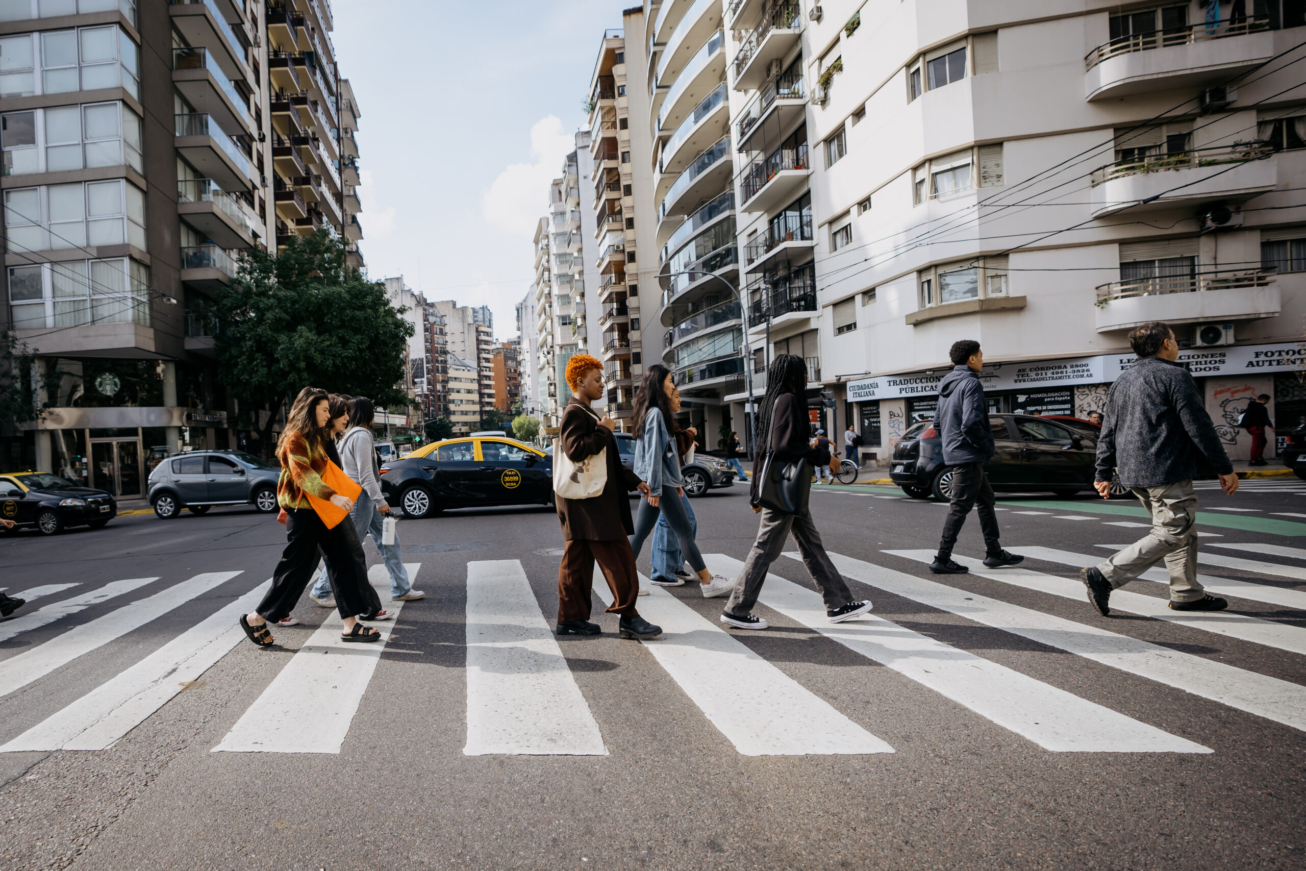 A group of students crosses a busy street in Buenos Aires.