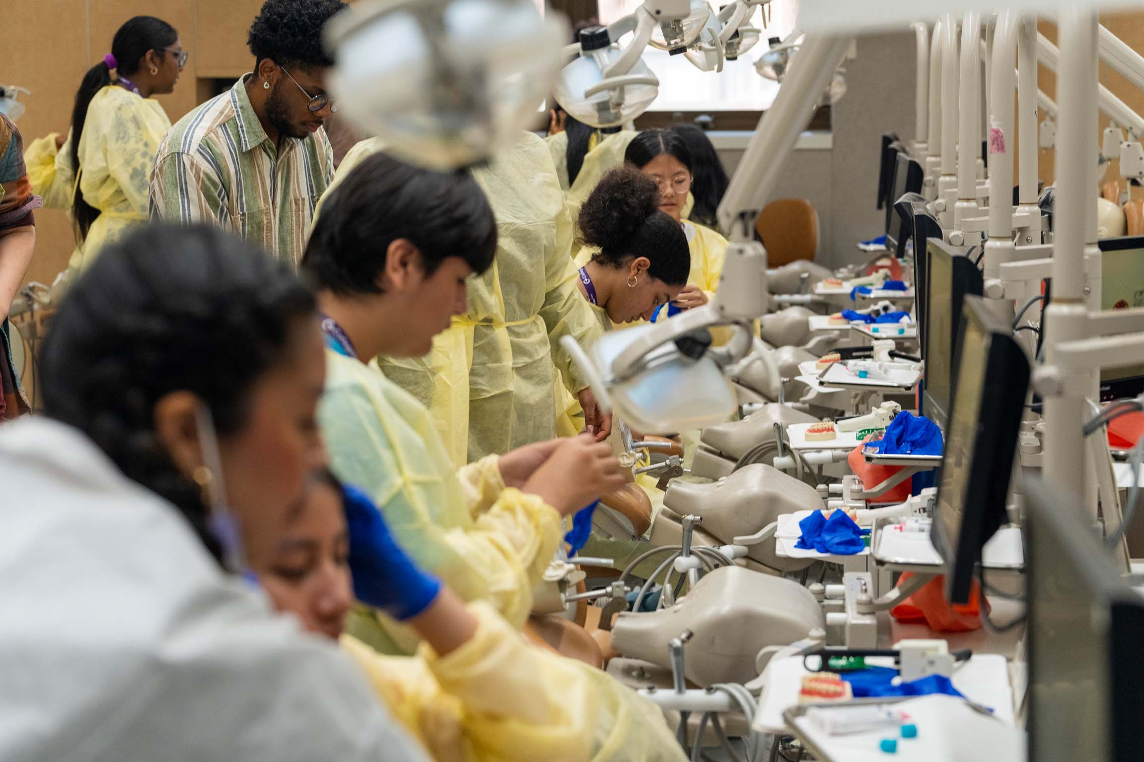 A large cohort of students working on lab equipment.