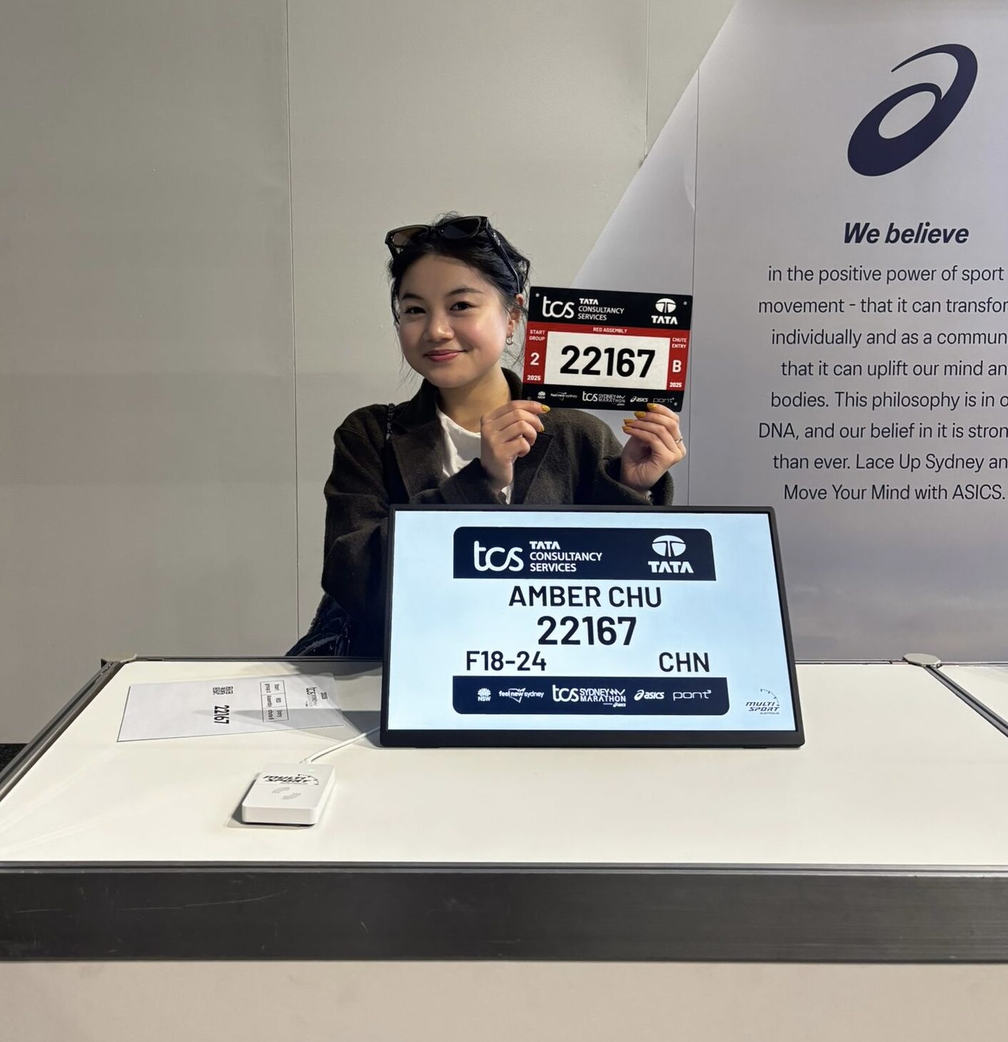 Student Amber Chu holding up her assigned number for the race.