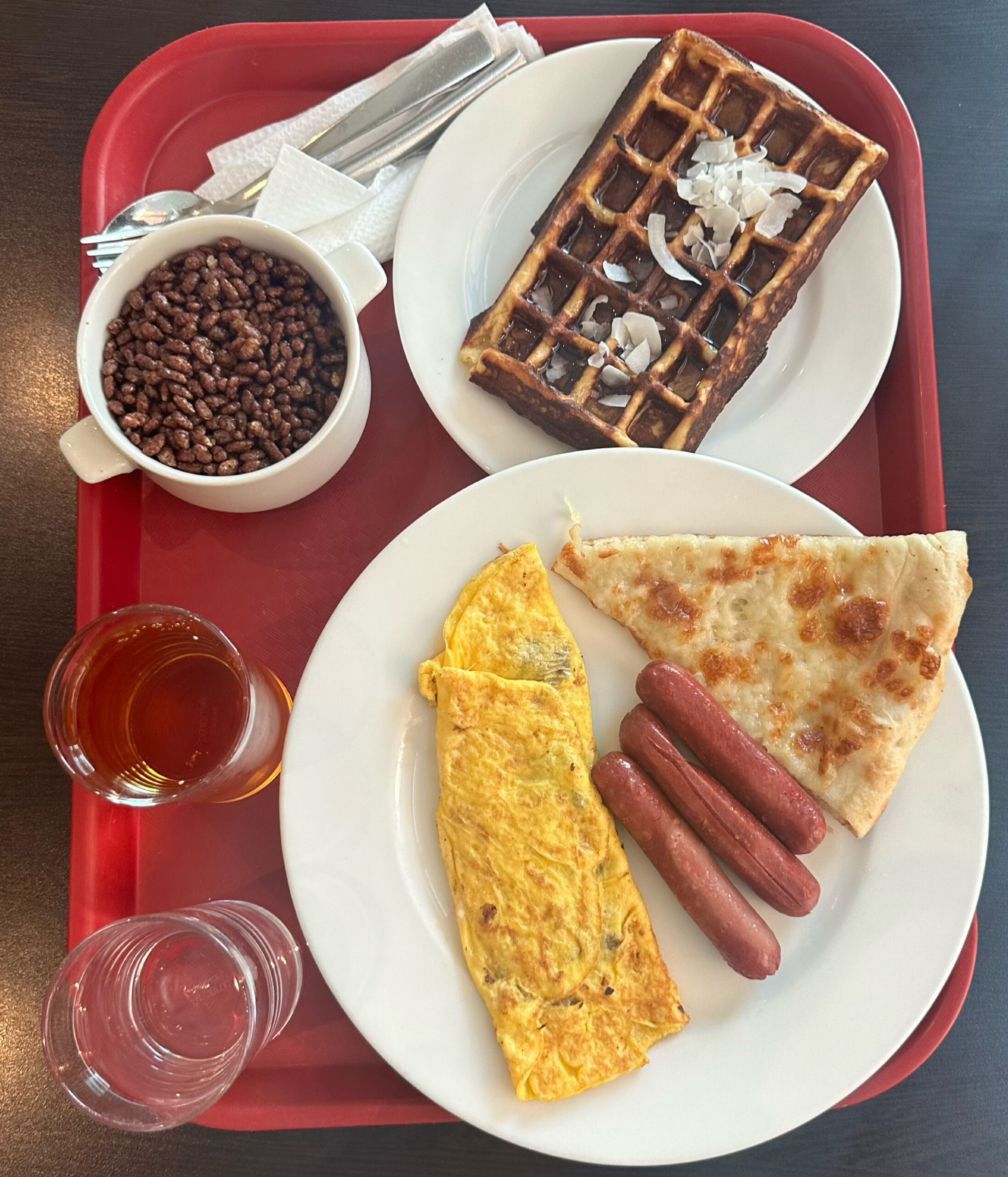 A full breakfast of an omelet and waffles.