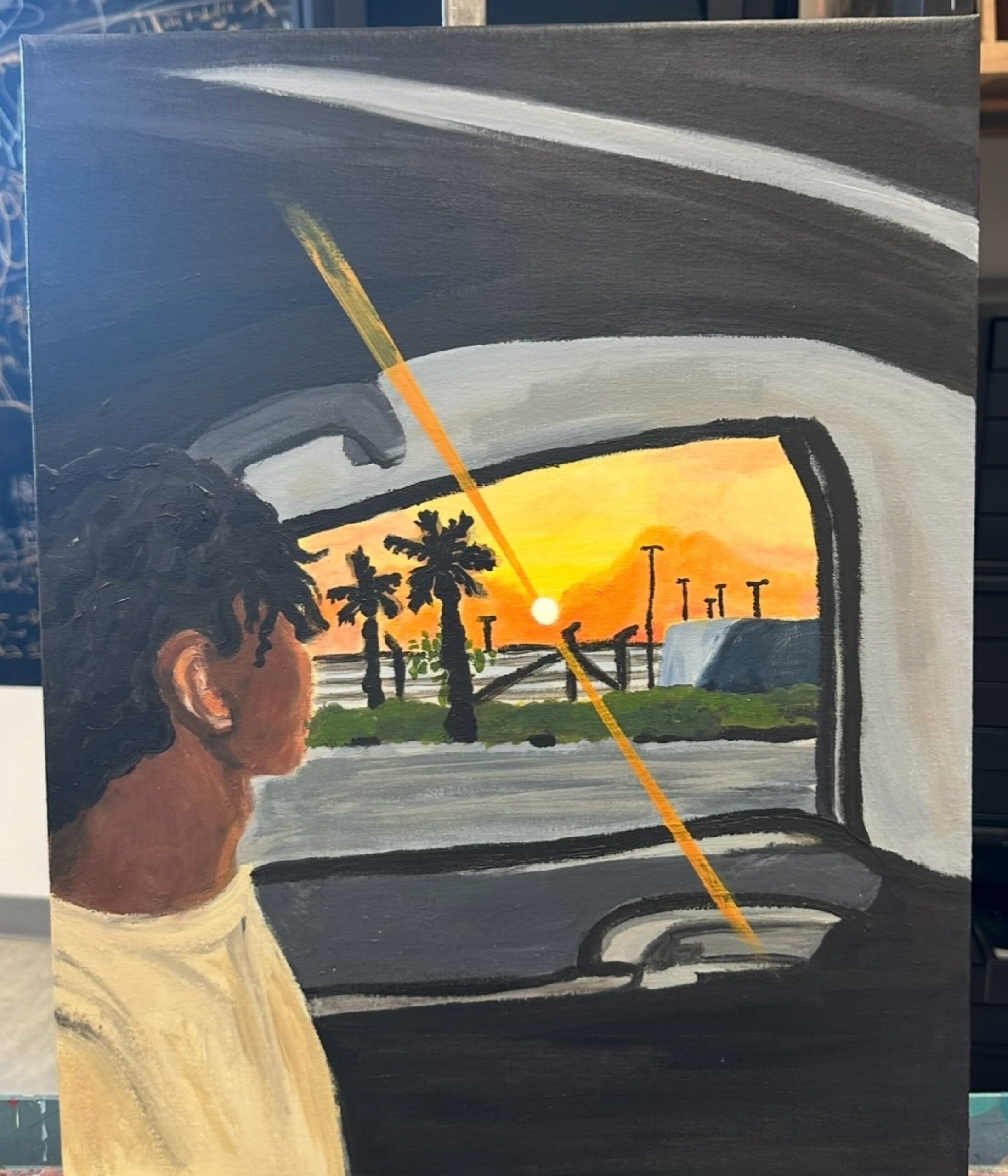 A painting of someone looking out a car window at sunset.