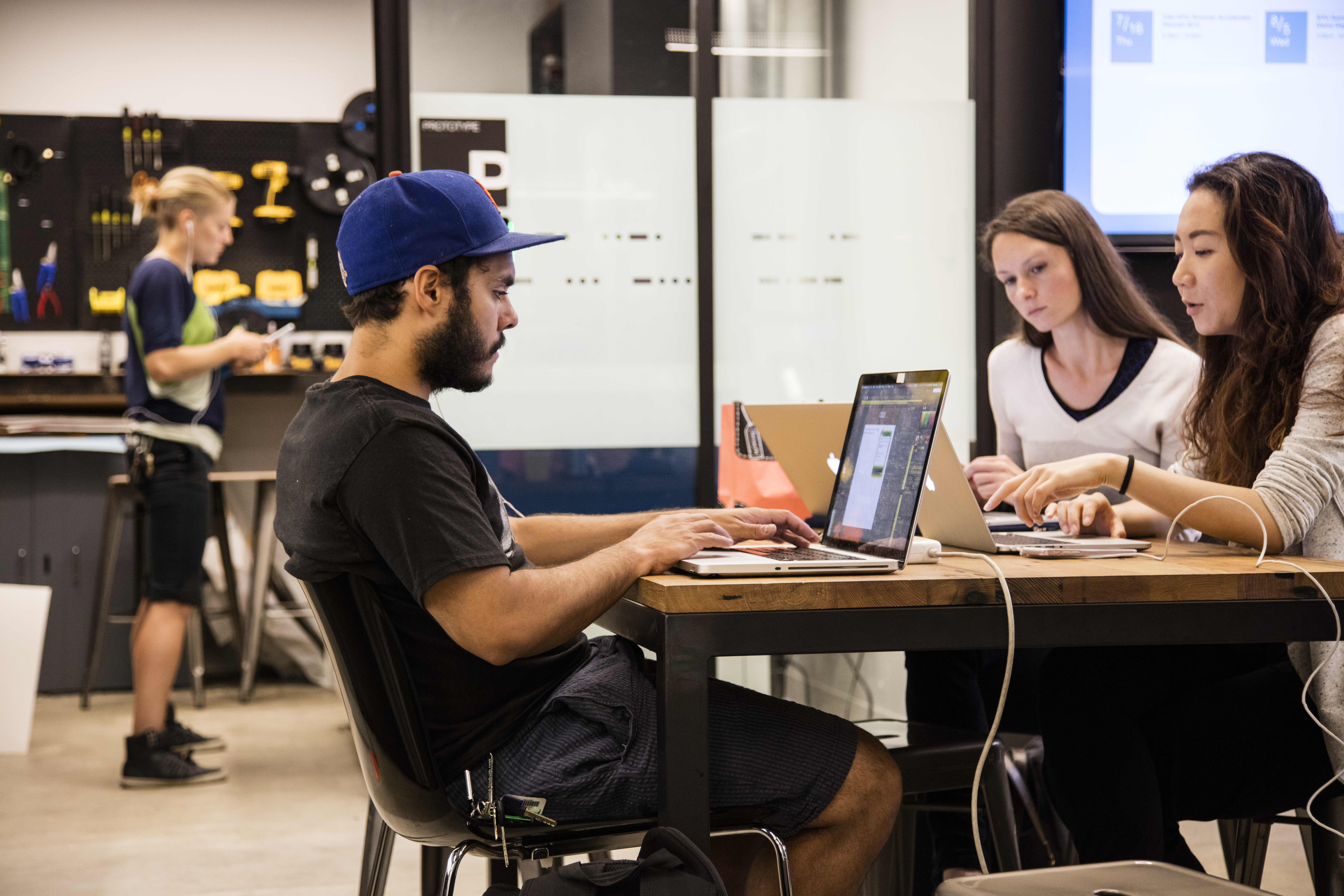 A group of students work in a conference area in the Leslie eLab.