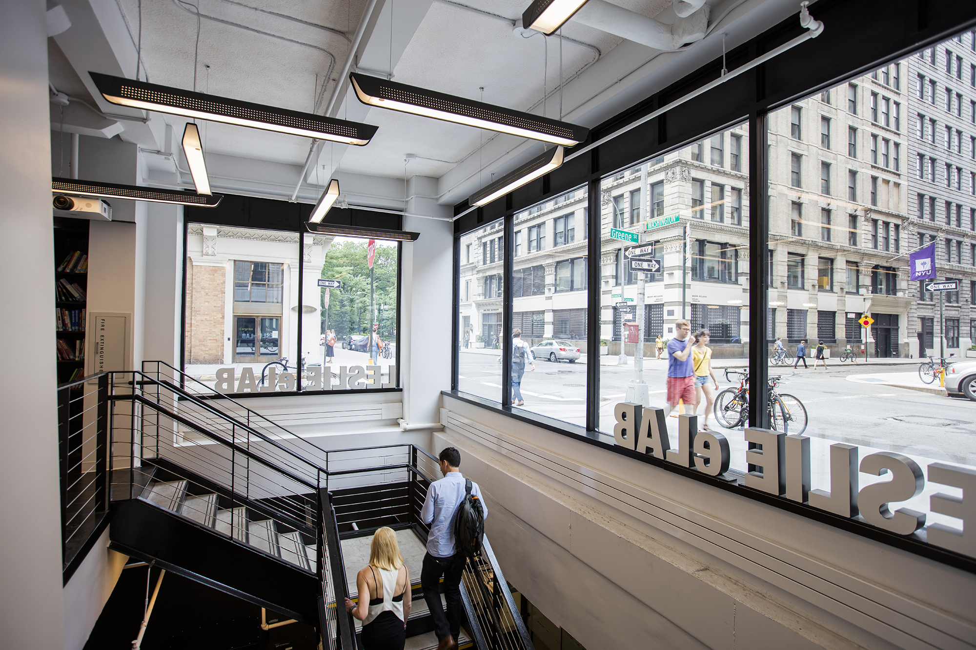 Two students walk up the stairs in the Leslie eLab.