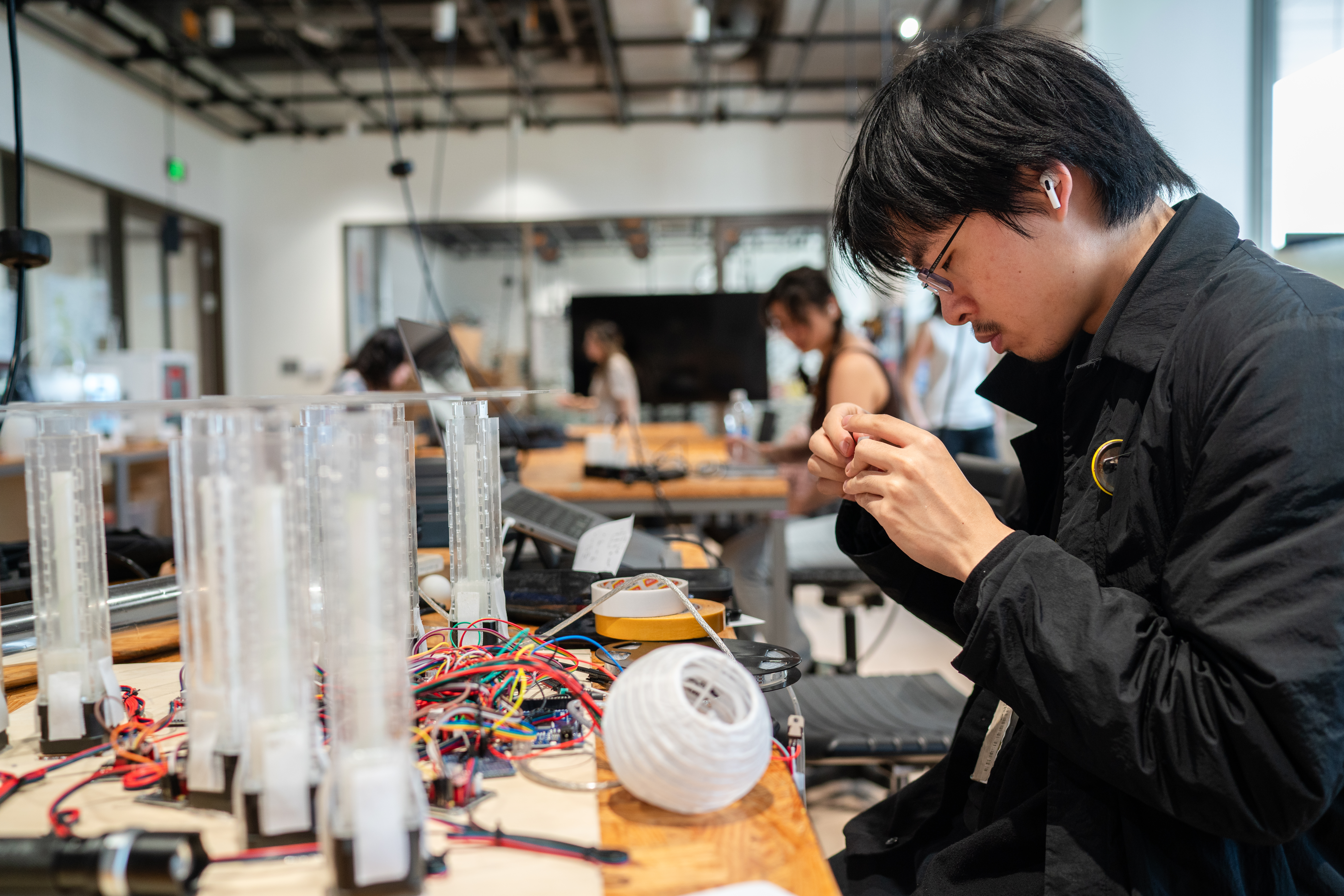 A student working with wires and cables.