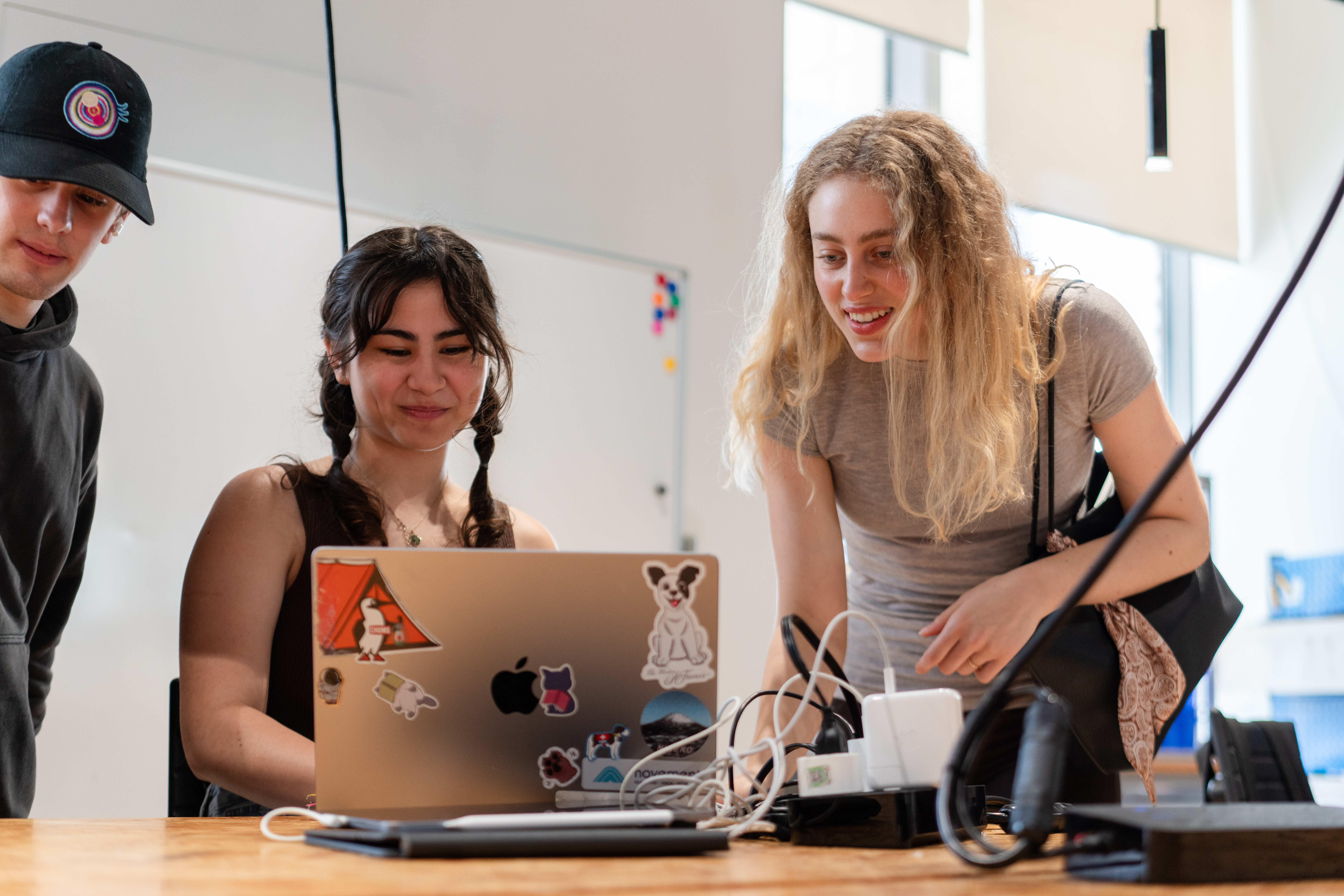 Three students working together in class.