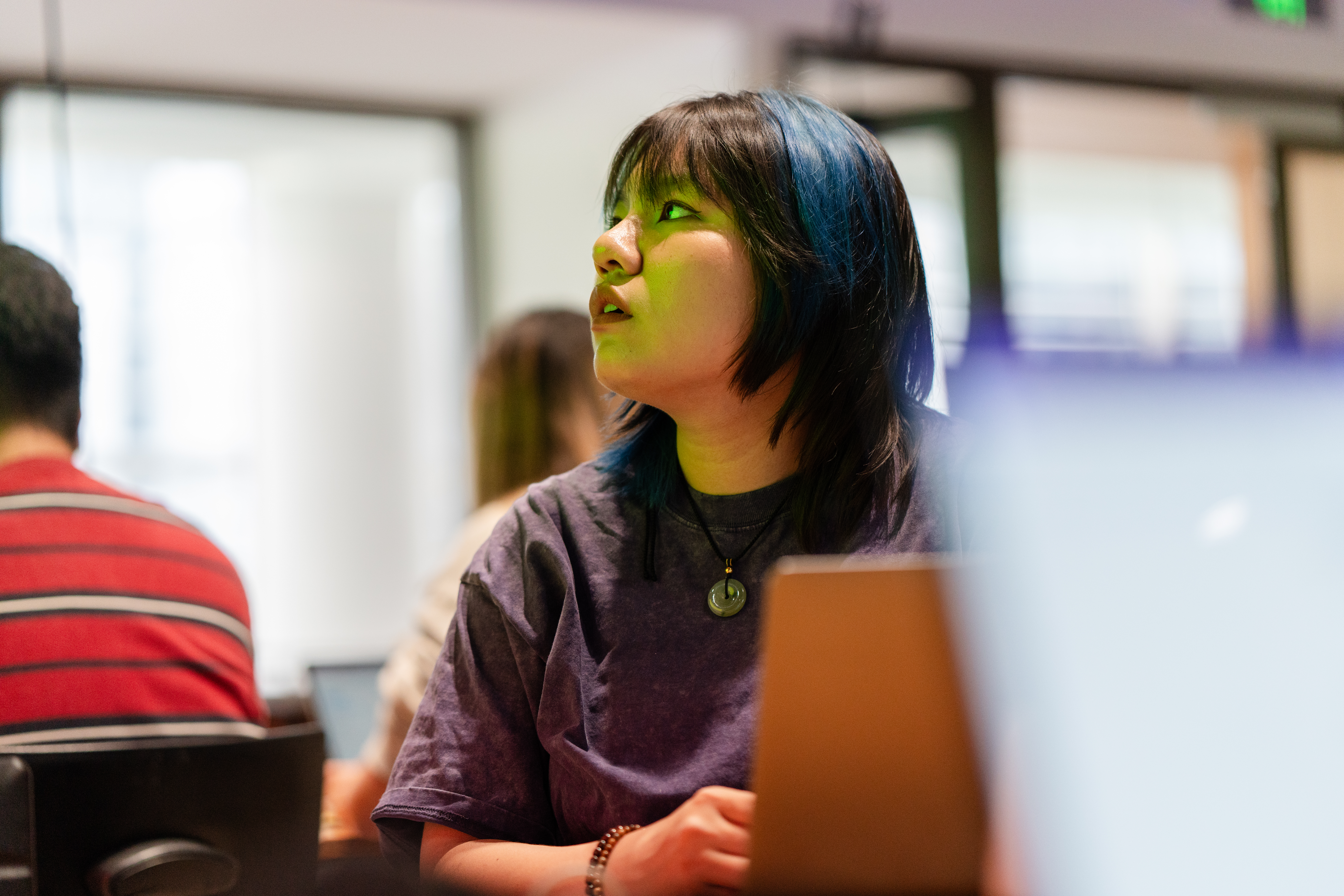A student with their laptop listening intently during class.