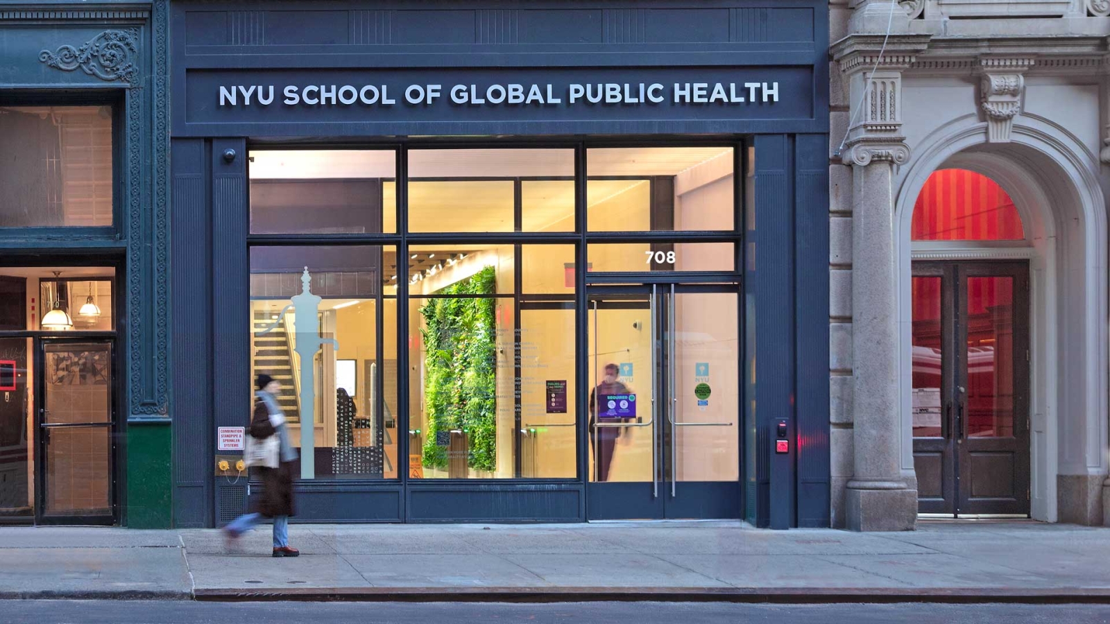 NYU's School of Global Public Health photographed from the street, showing large windows and a modern building