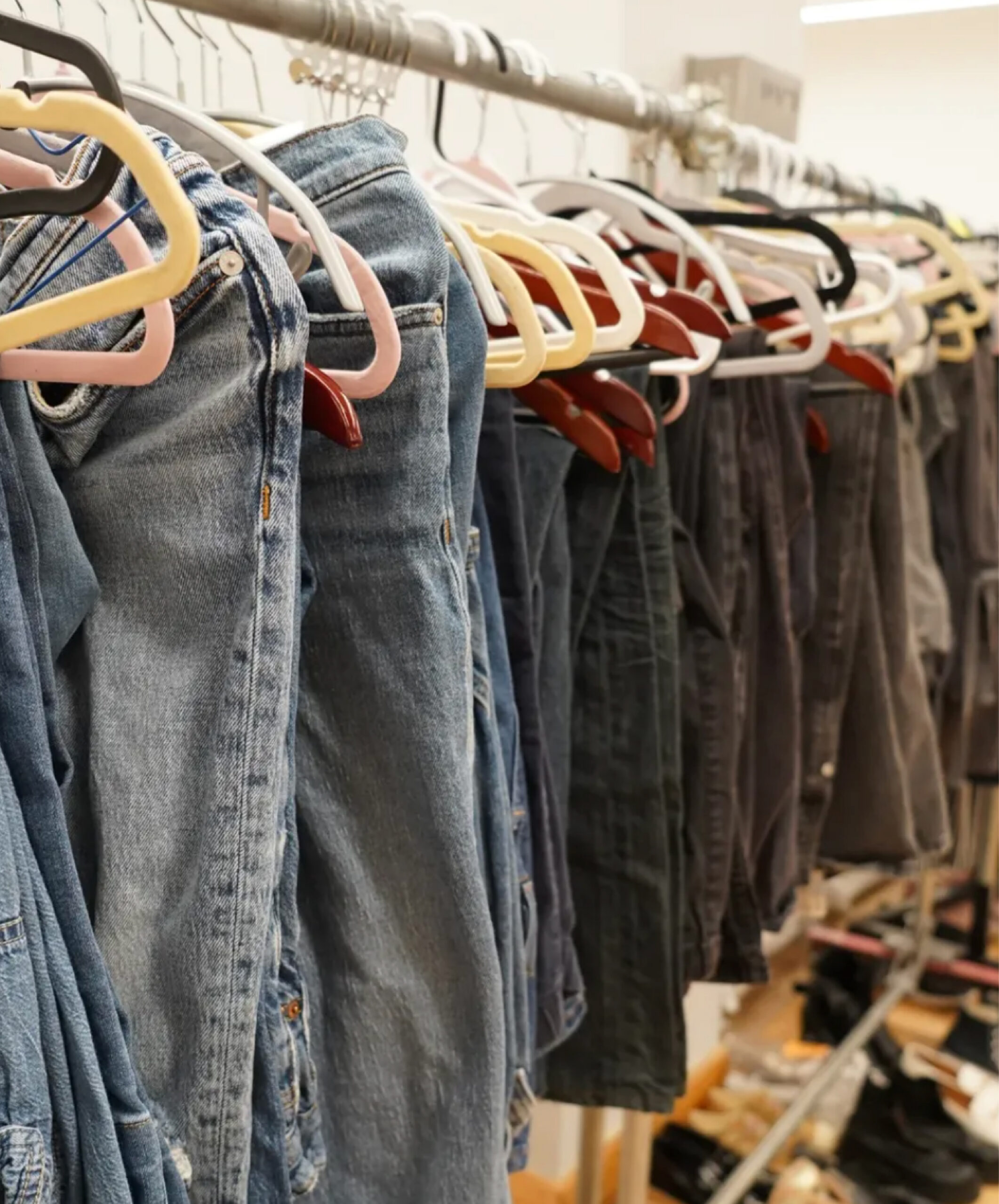 Clothing racks with jeans and clothes.