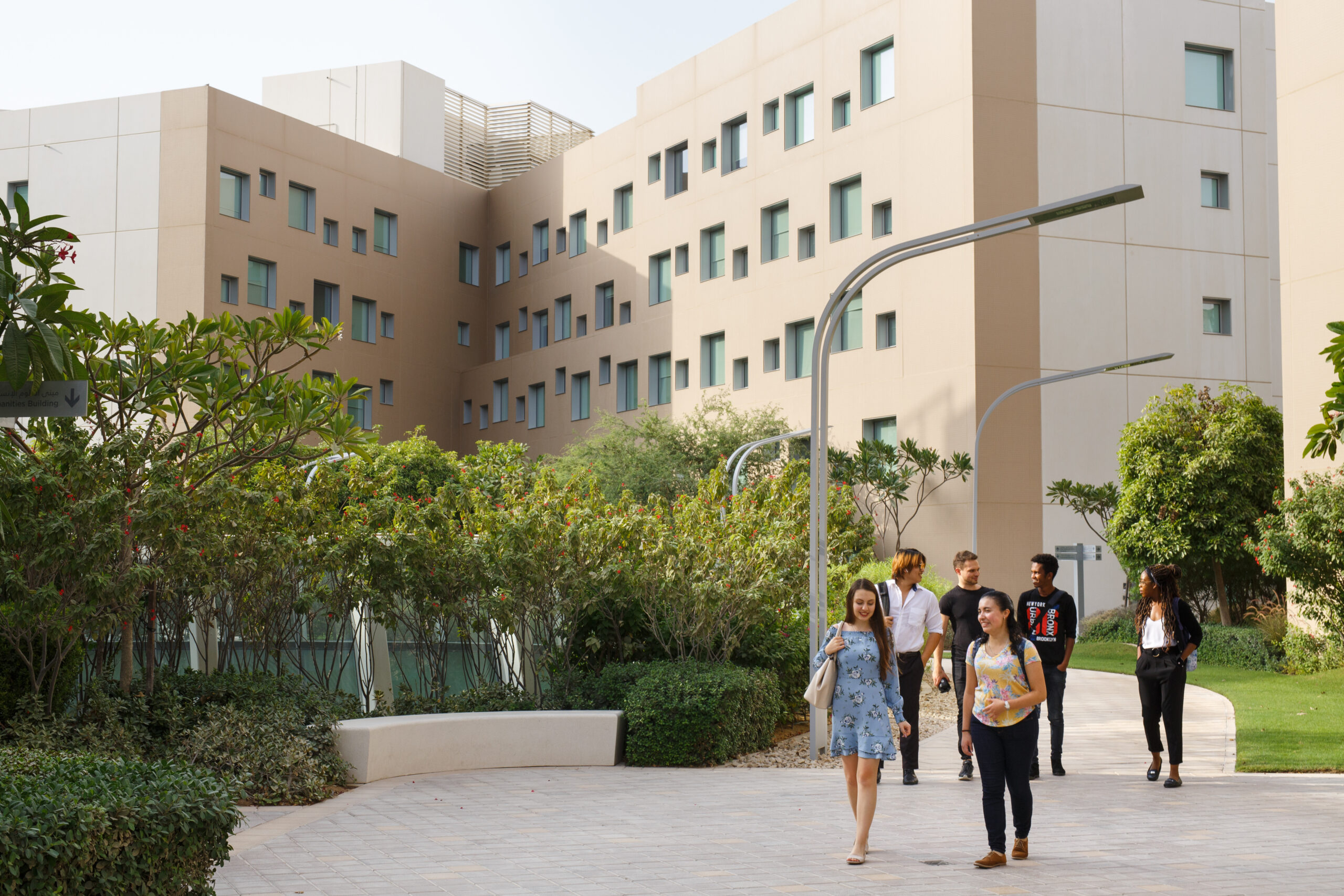 A group of students walking through the NYU Abu Dhabi campus.