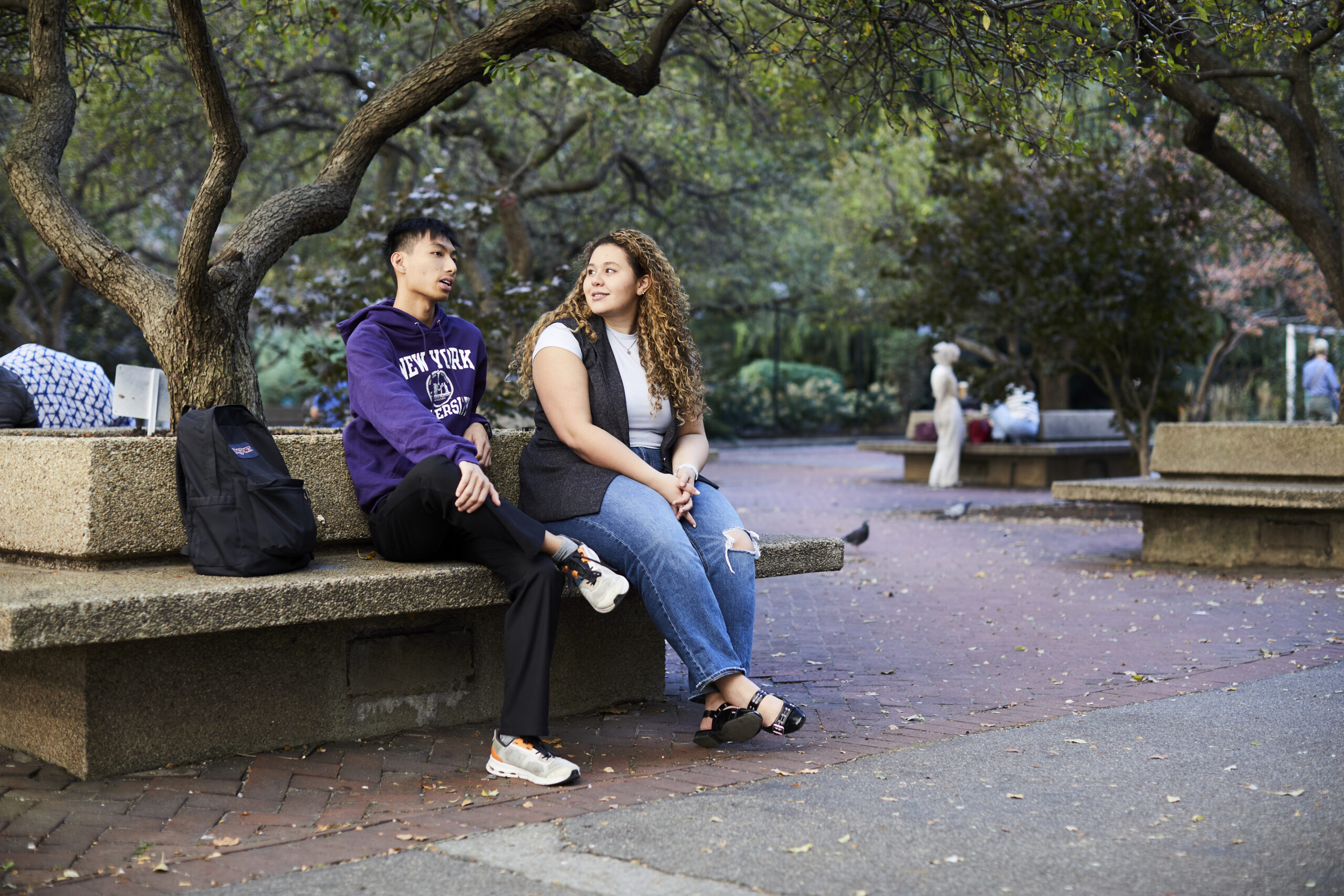Two students spending time outdoors and chatting.