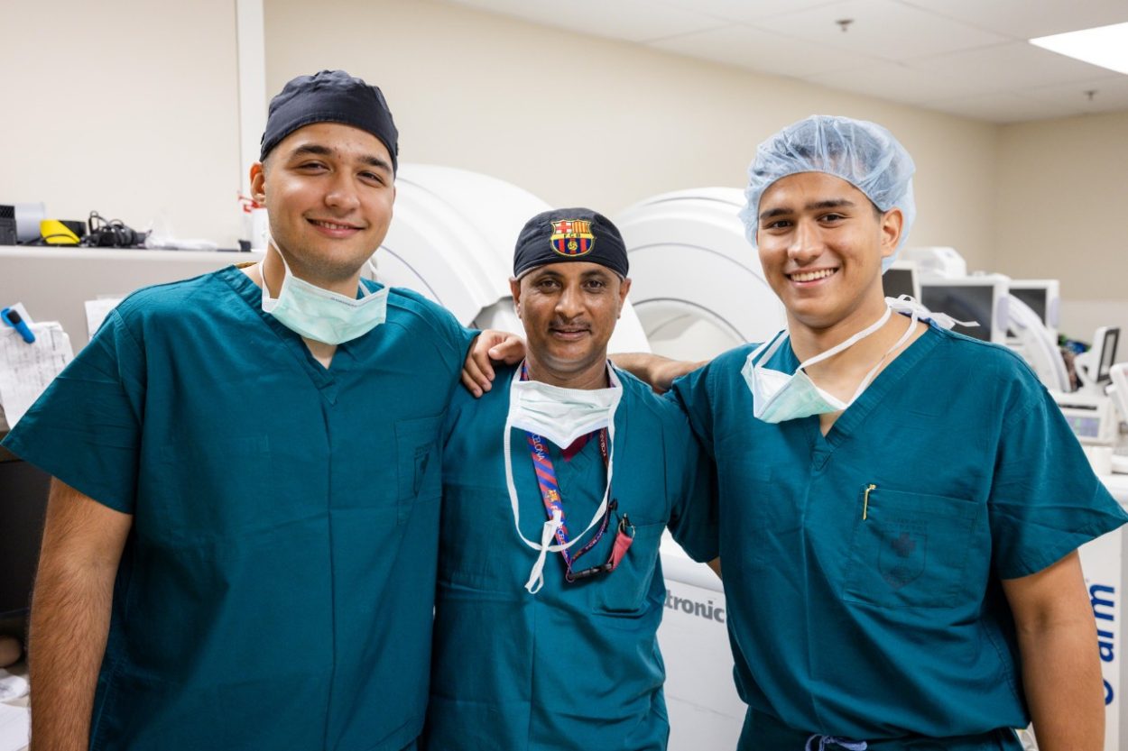 Massimo and his brother pose with a doctor who is their mentor.