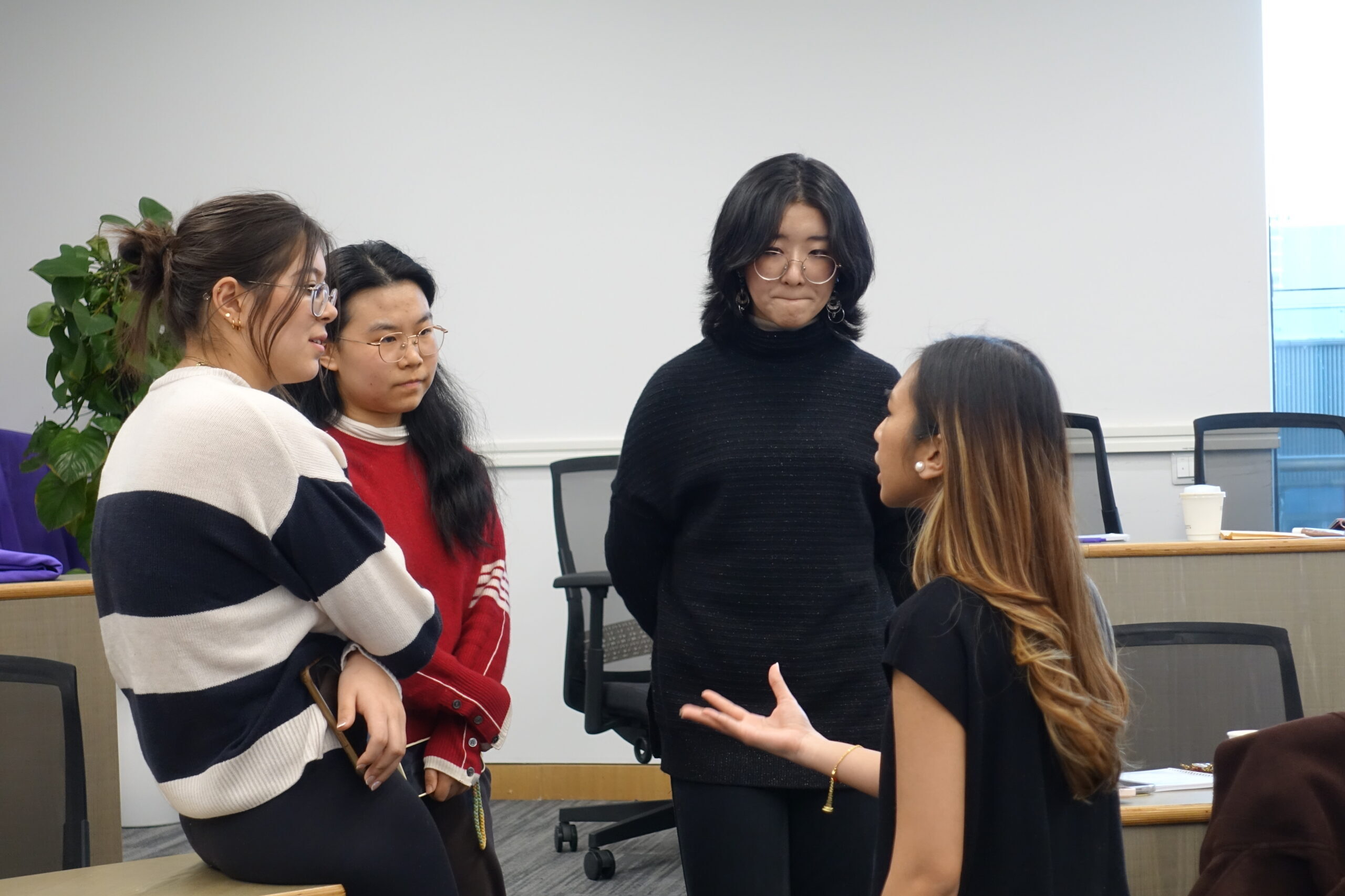 A group of students talk together.