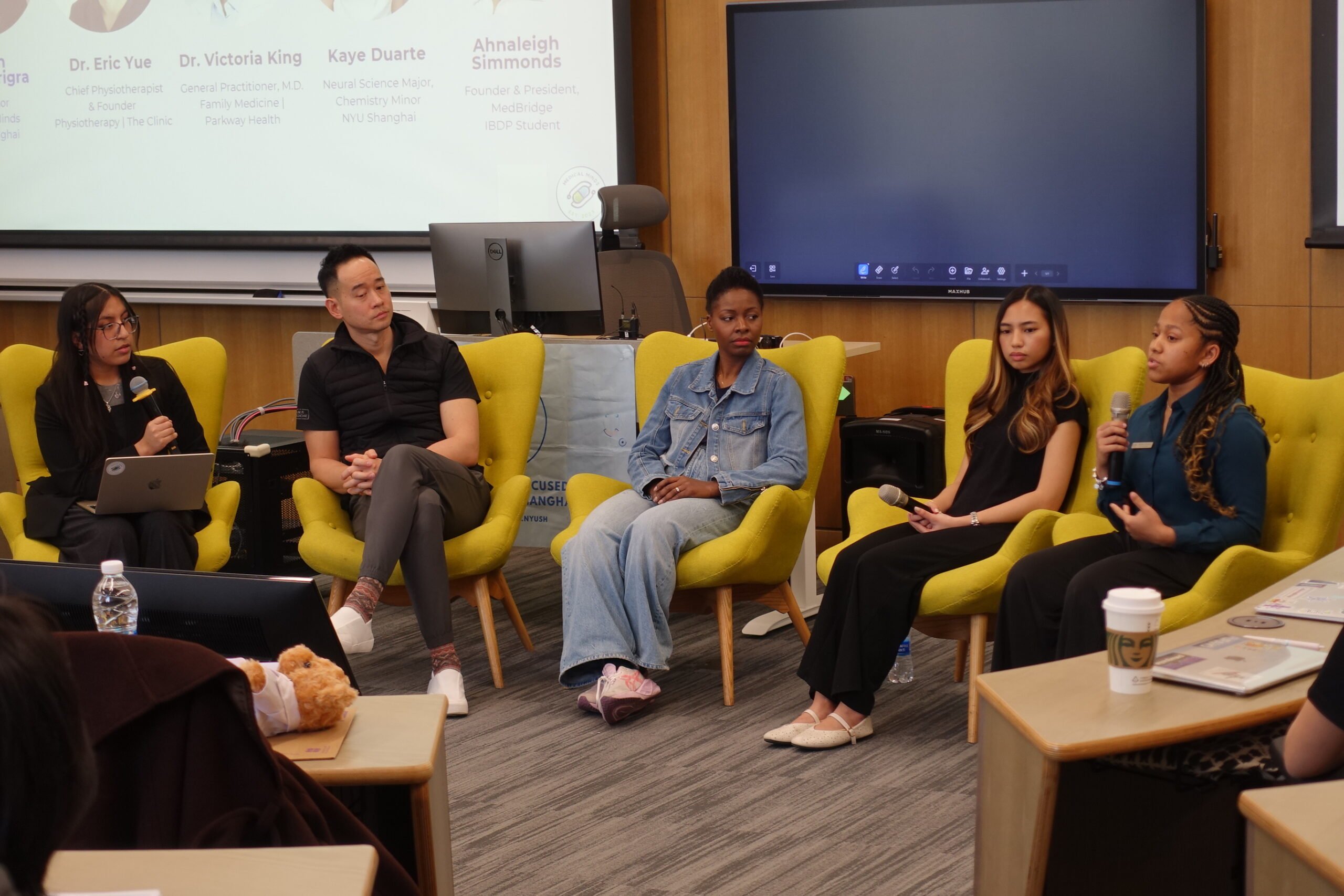 A panel of healthcare professionals speaks to students.