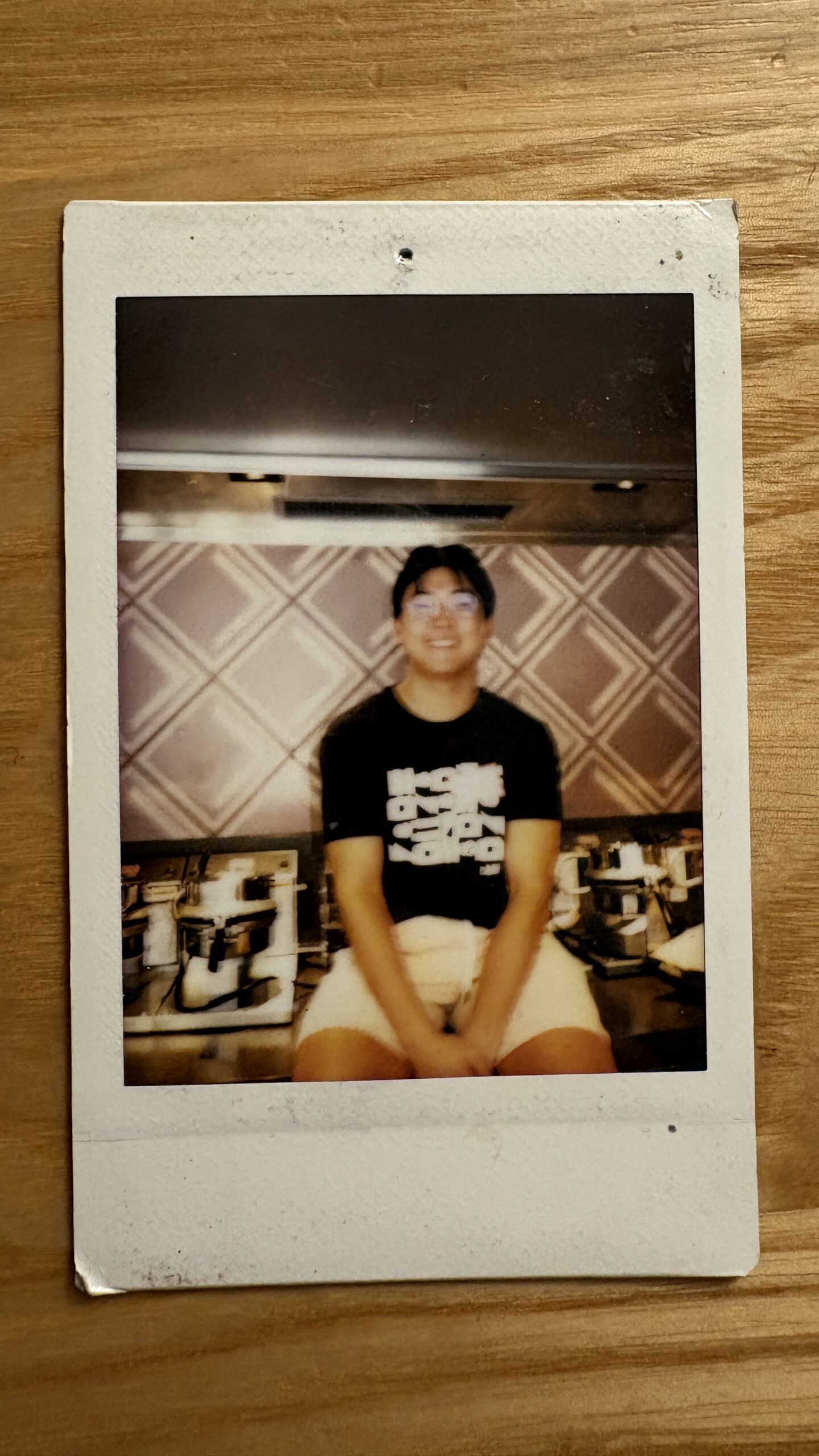 polaroid picture of me working at the ice cream shop, sitting next to the waffle irons