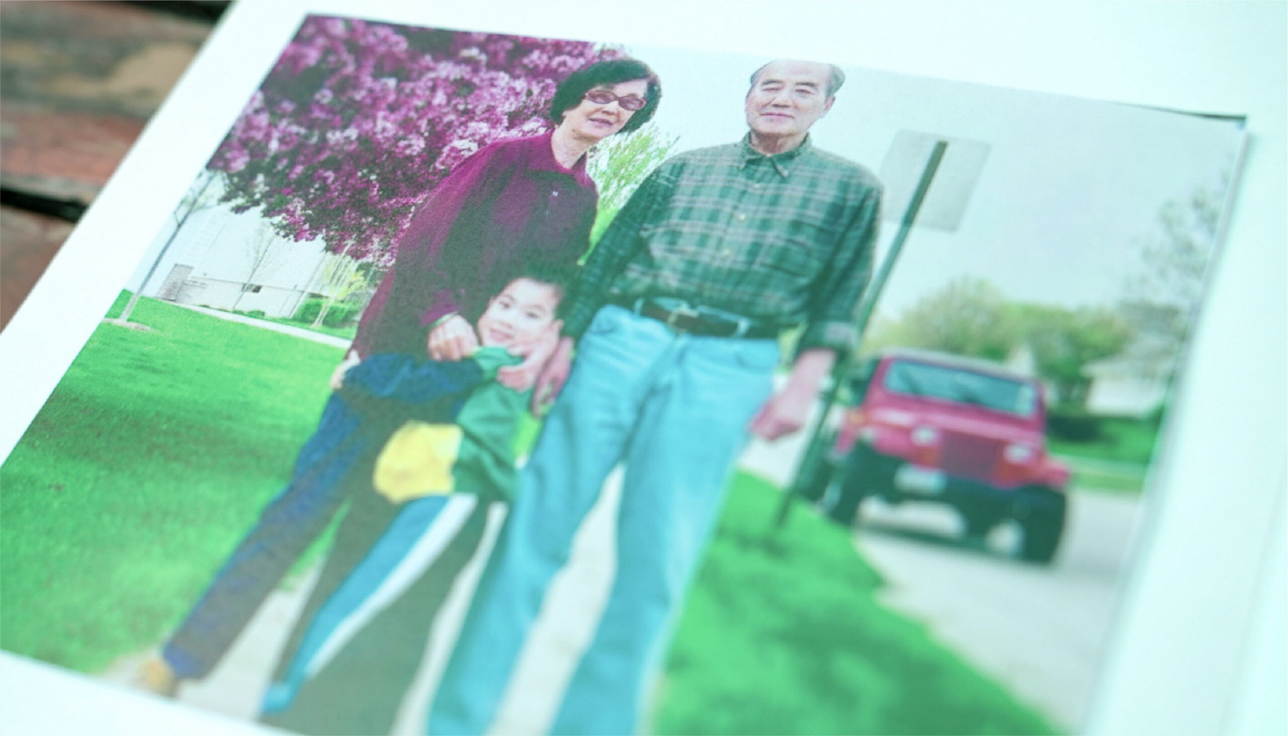 Addison Zhang, as a child, stands with his grandparents.