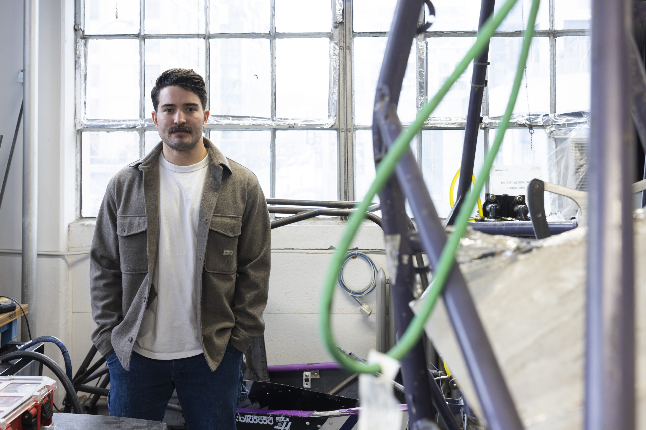 Vinnie Gallegos posing for a photo in a workspace.