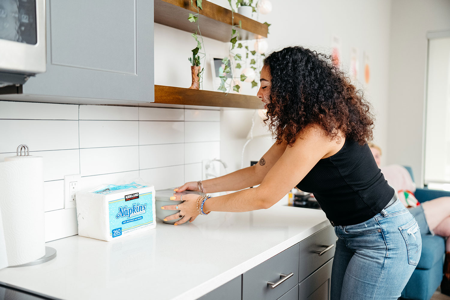 A student places a bowl on a countertop in their new living space.