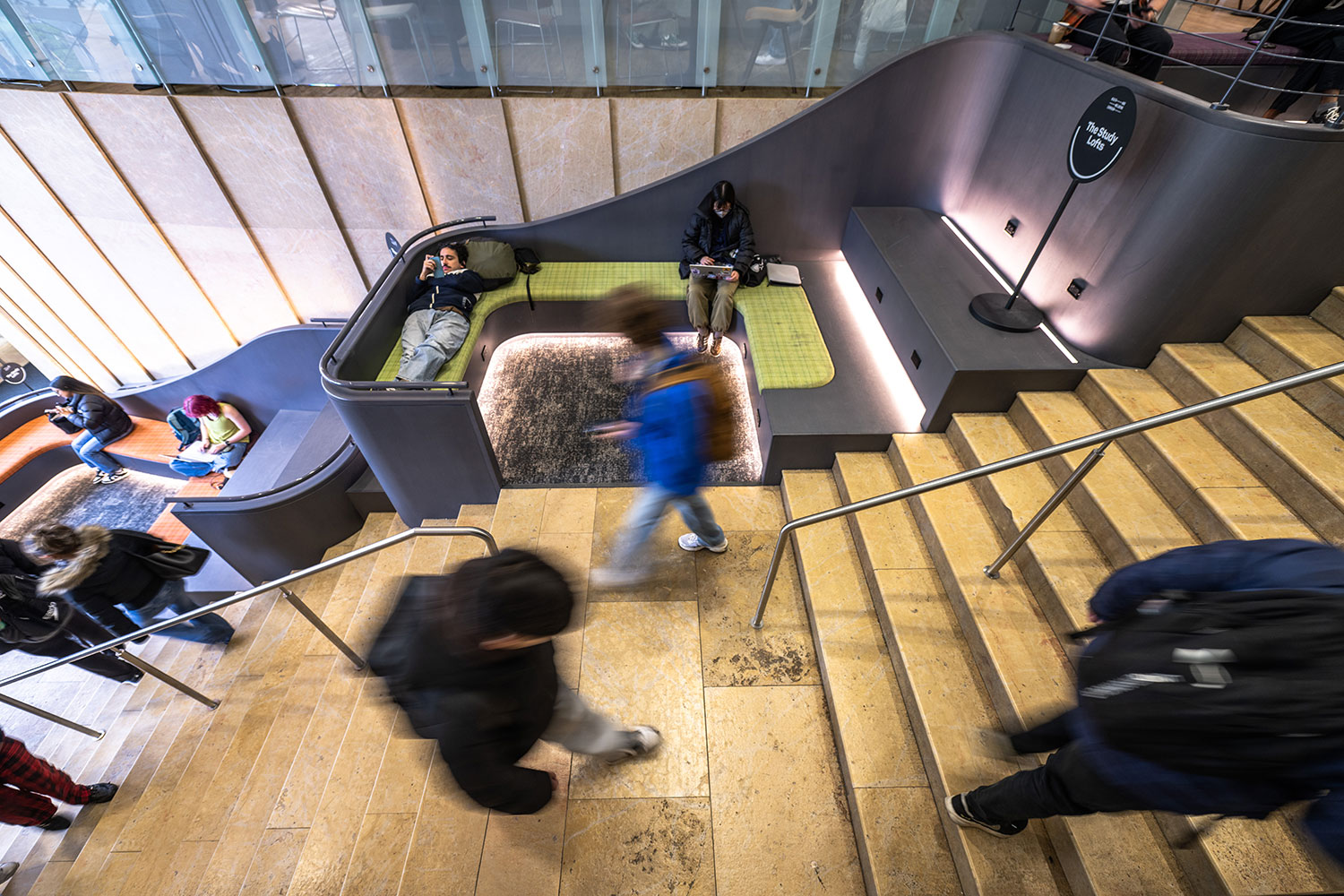 Students walking down the Kimmel staircase.