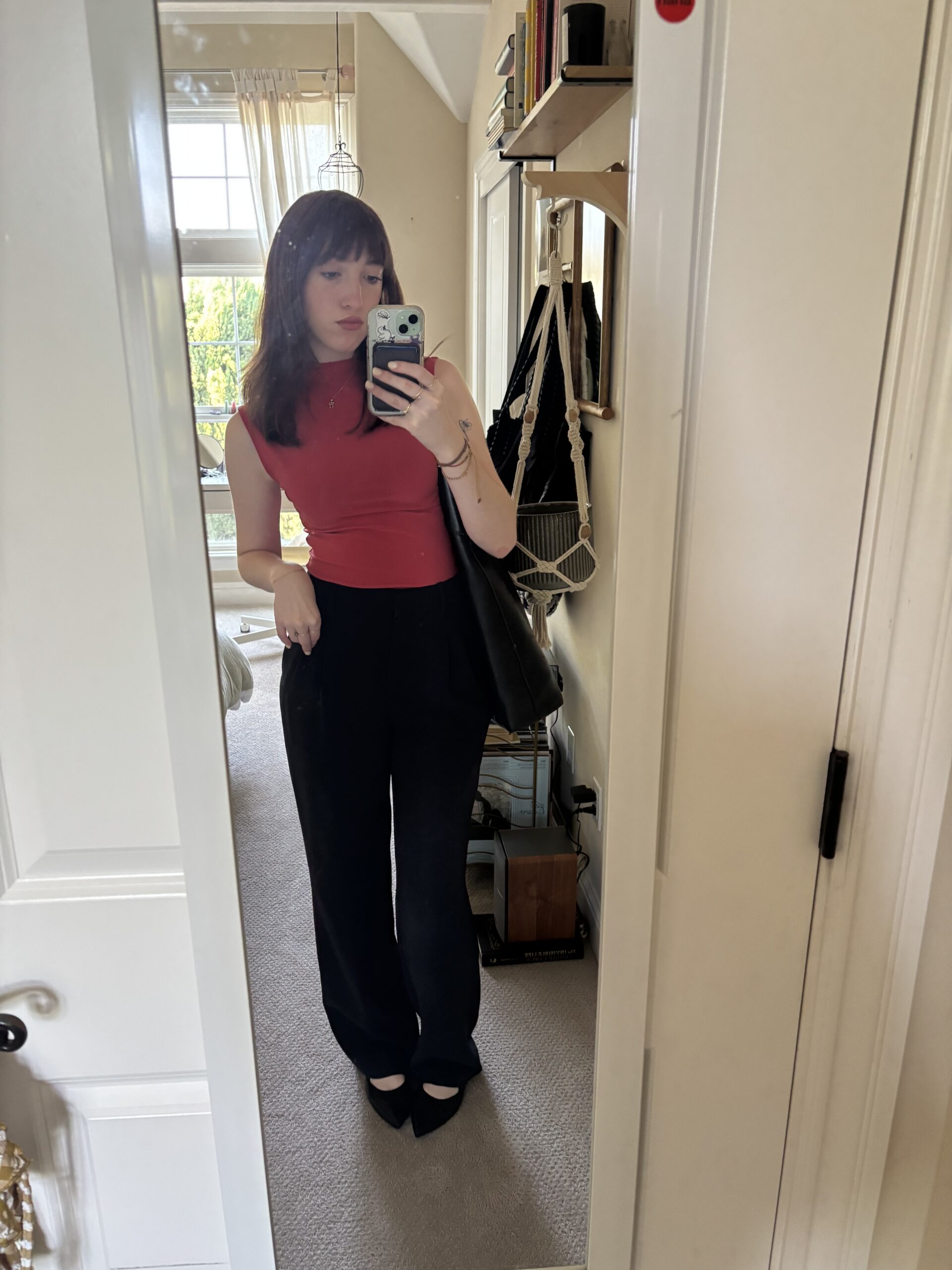 girl in mirror wearing red top and black pants