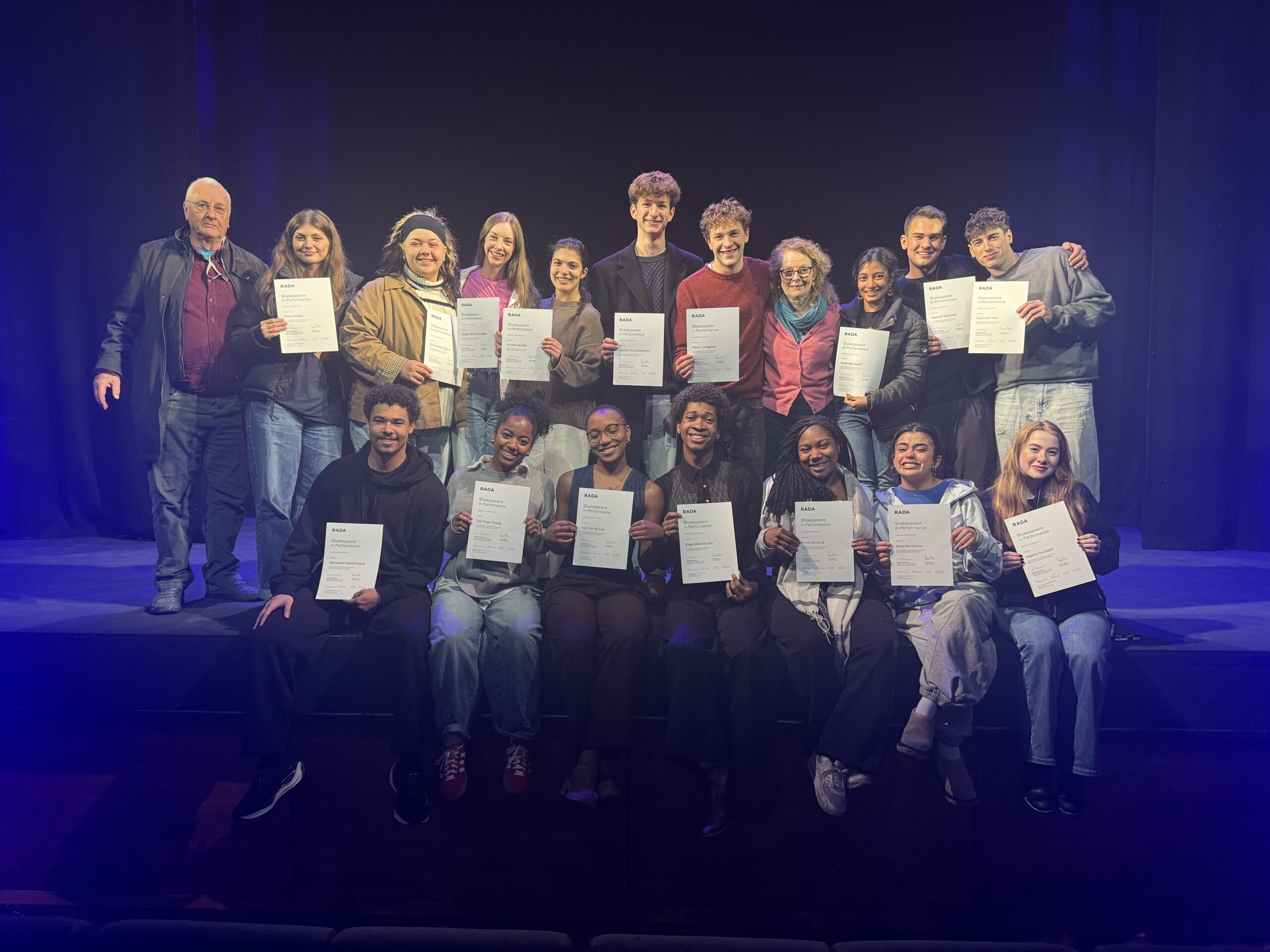 Group of NYU actors holds their graduation certificates from the Royal Academy of Dramatic Art.