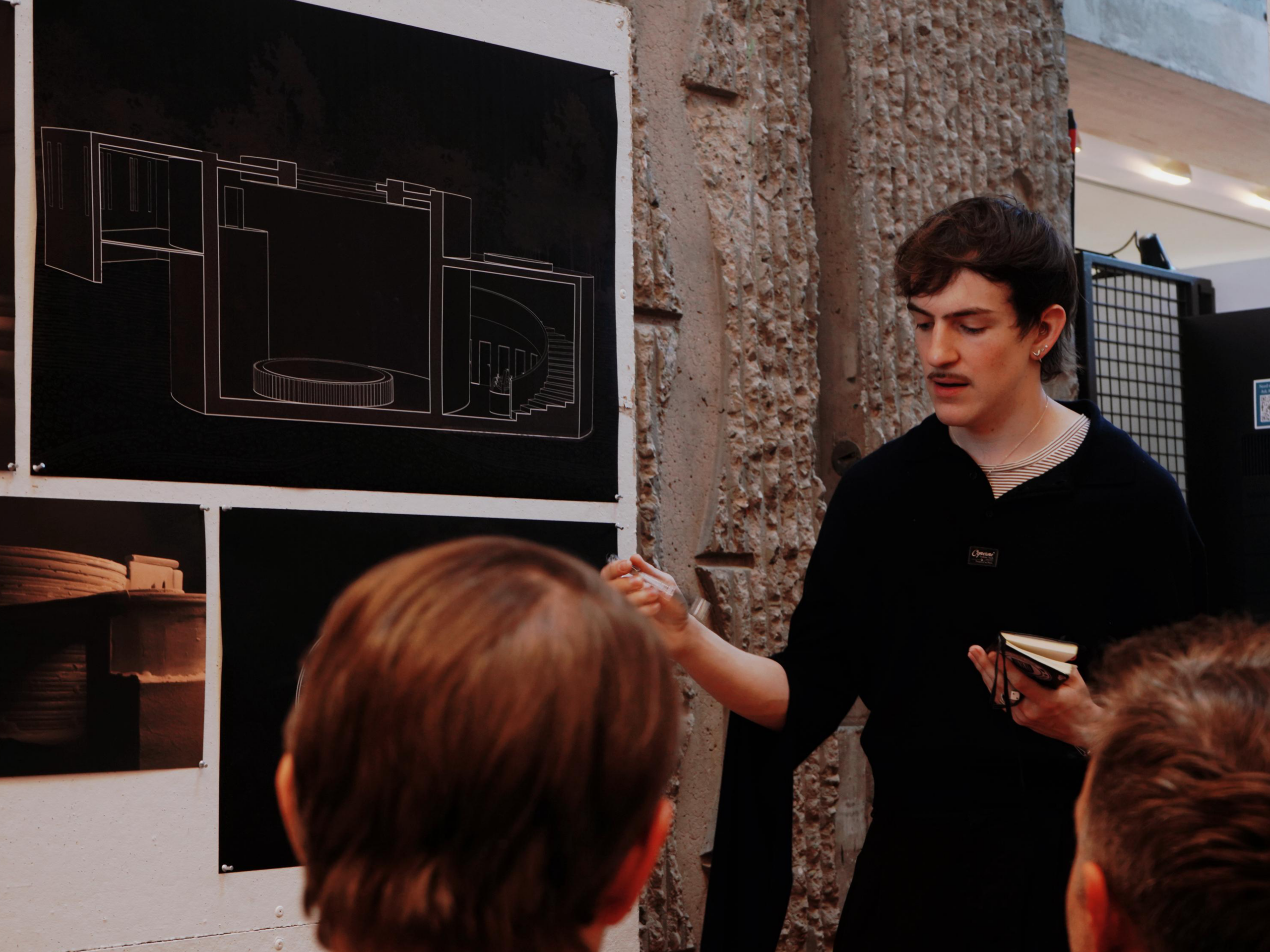 Ben Cresto presents his architectural project to a group.