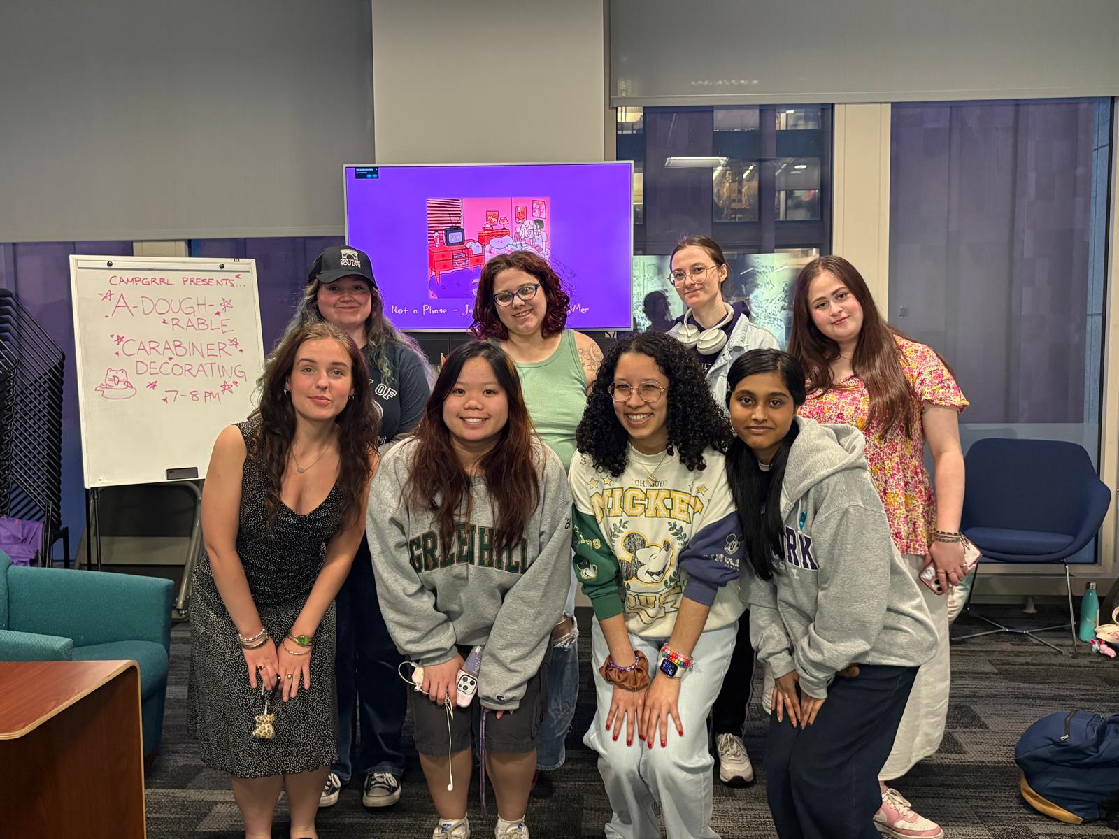 A group of students pose for a photo at a Campgrrl meeting.
