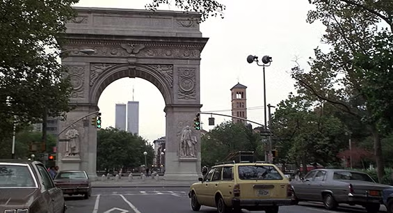 Still from When Harry Met Sally showing cars passing by the Washington Square Arch in New York City.